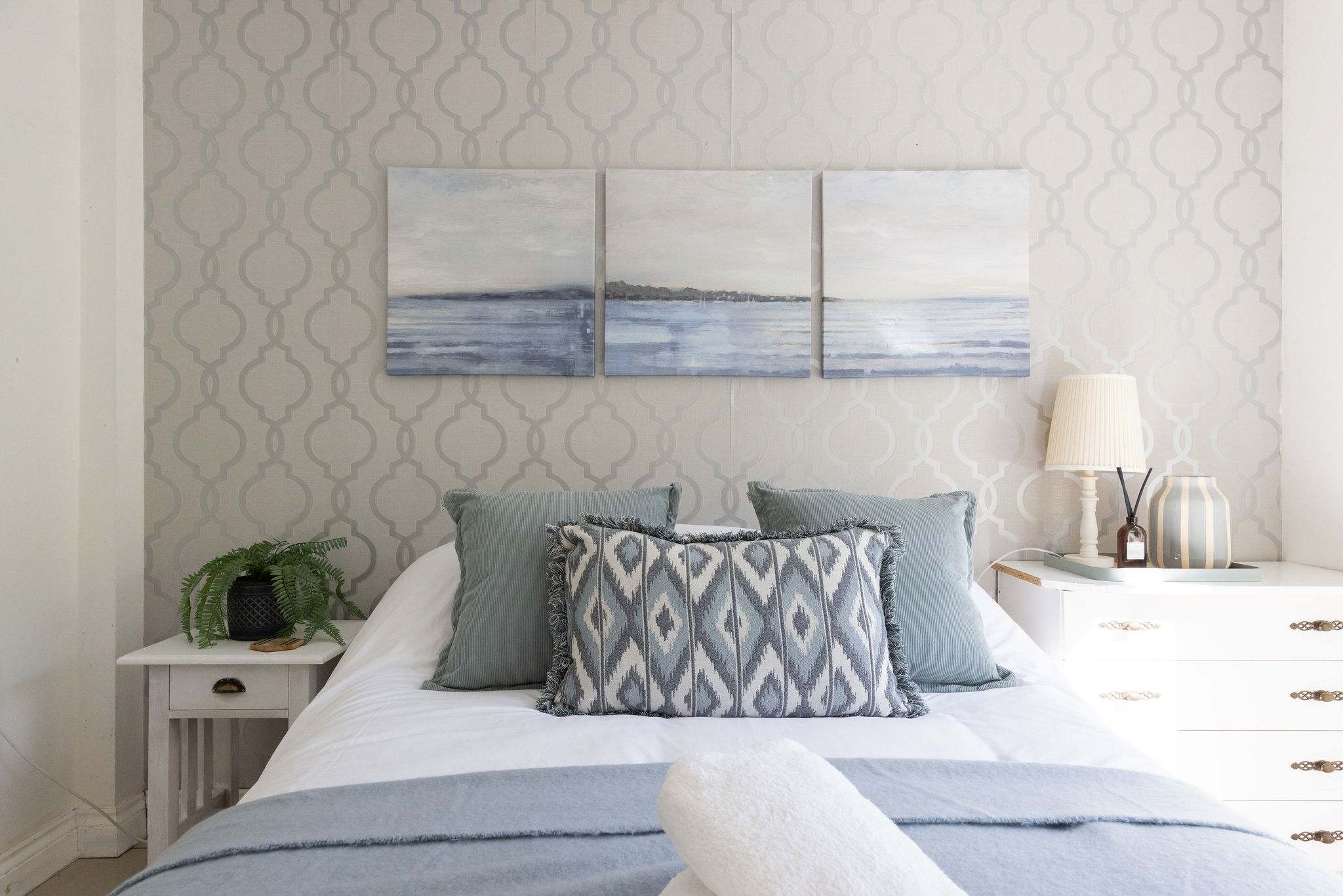 Admire the soothing seaside artwork from the comfortable bed of this beautiful coastal retreat.