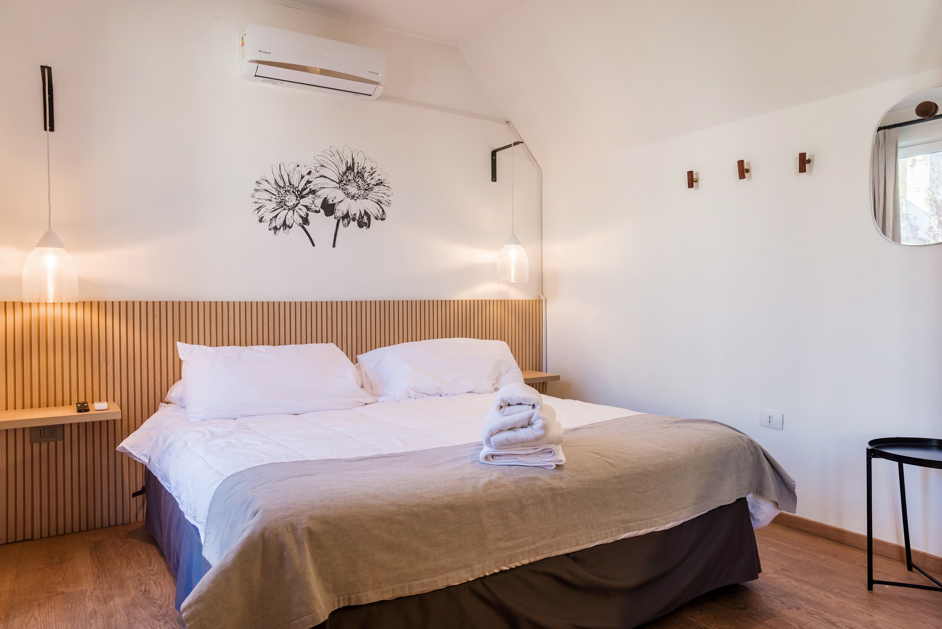 Relax in this cozy bedroom with a comfortable bed, soft lighting, and stylish decor.