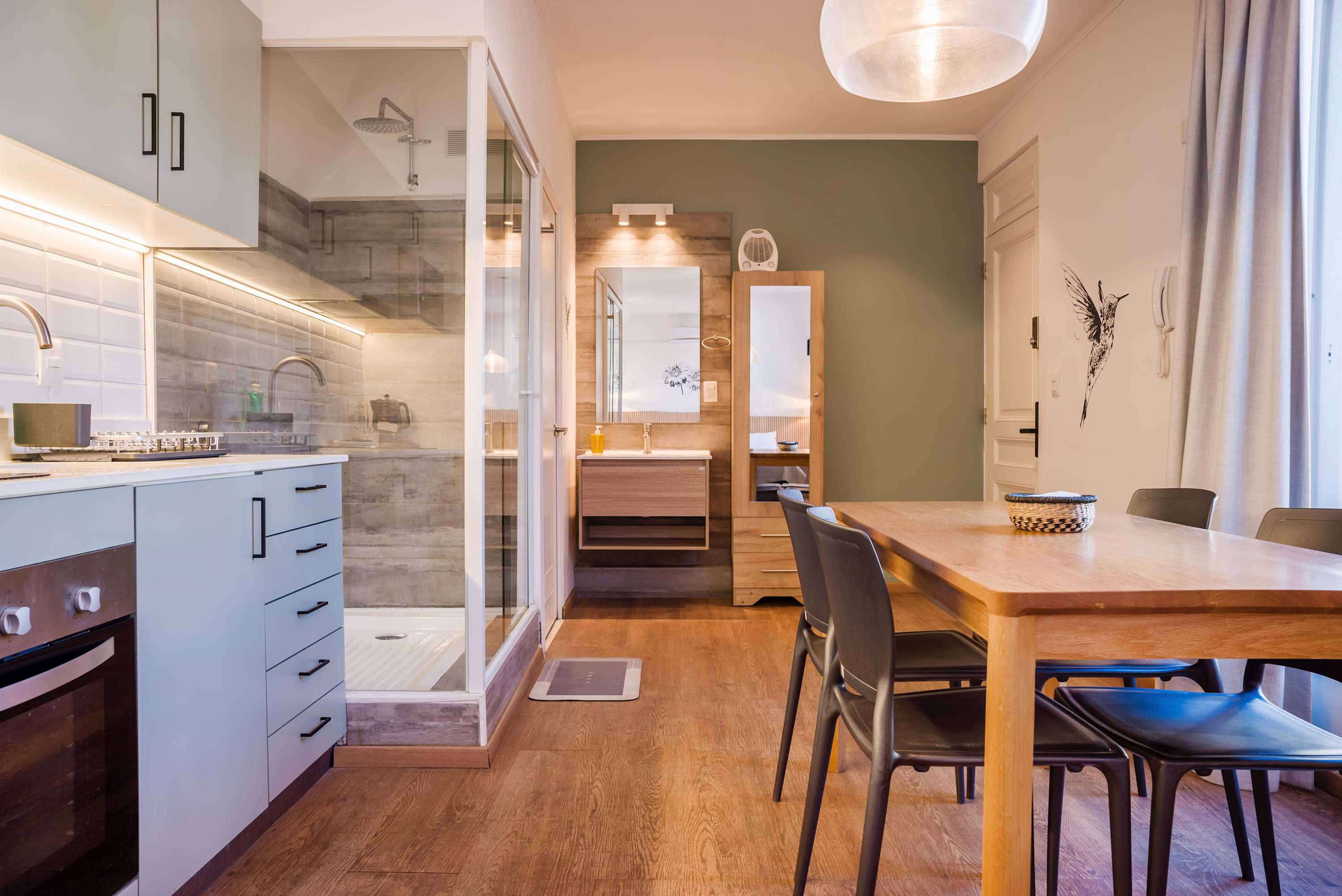 Cozy studio kitchen with modern amenities and a stylish dining area, perfect for a comfortable stay.