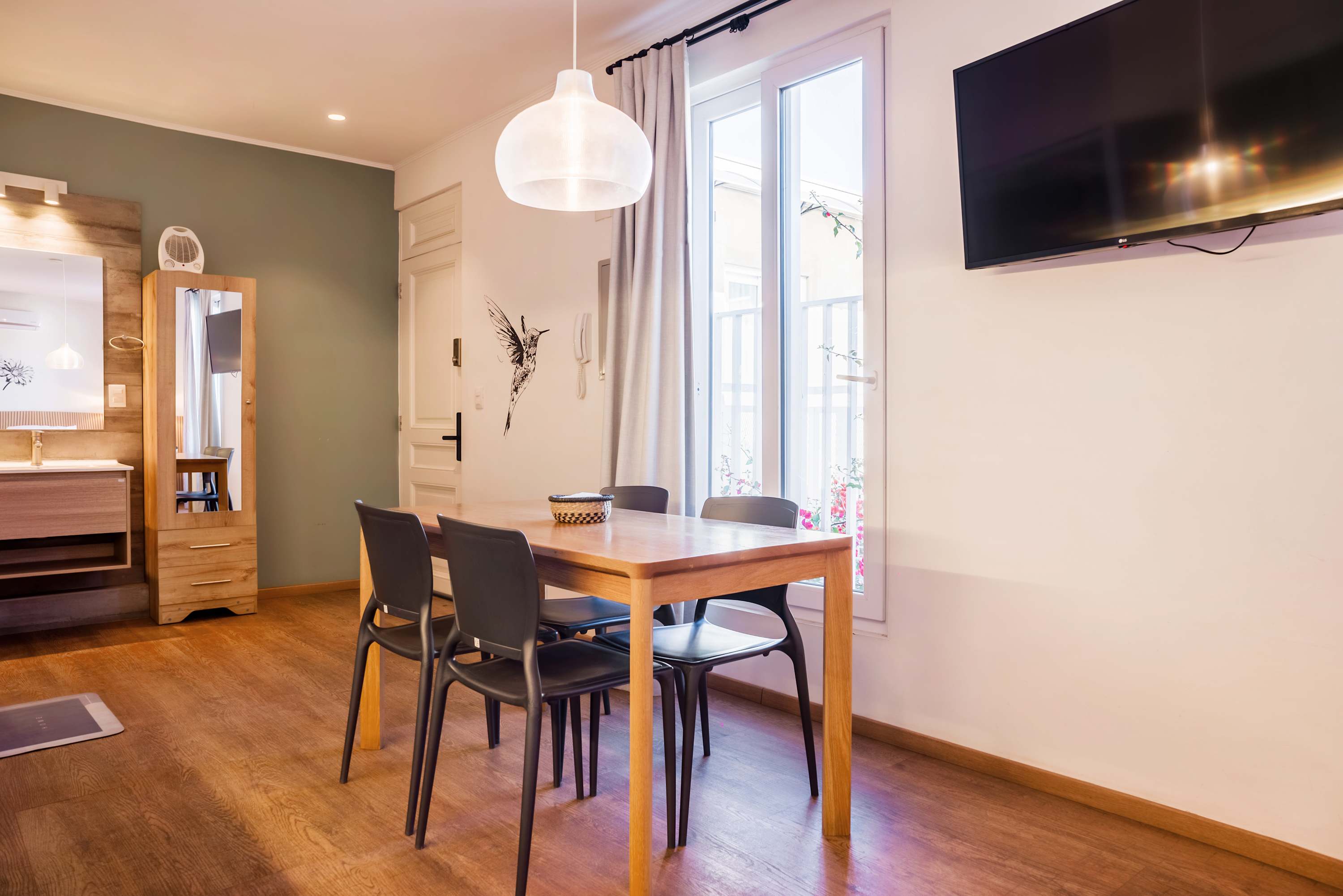 Cozy dining area with natural light and modern amenities, perfect for intimate meals.