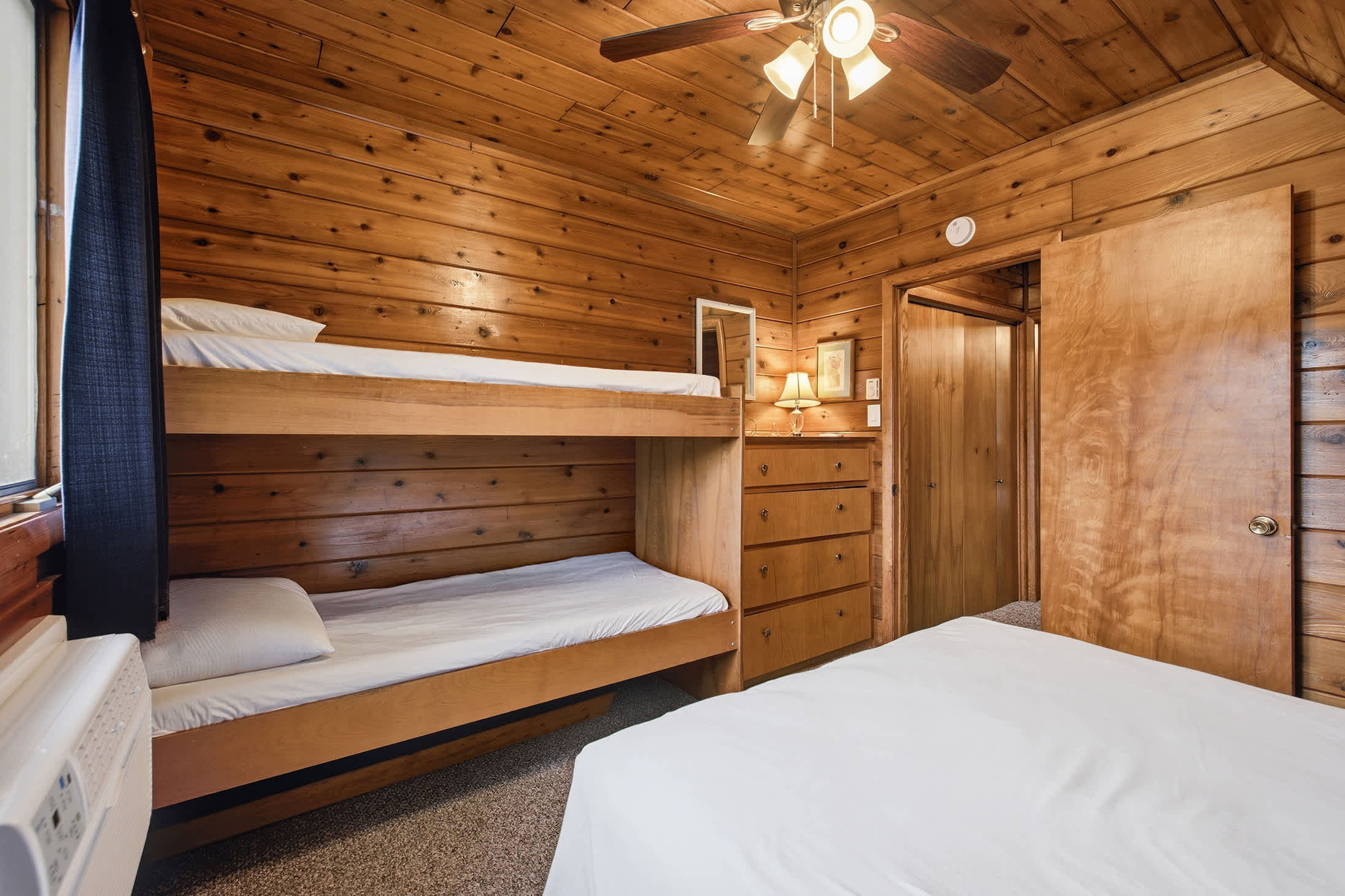 Queen bed and built in bunks give families flexible sleeping options.