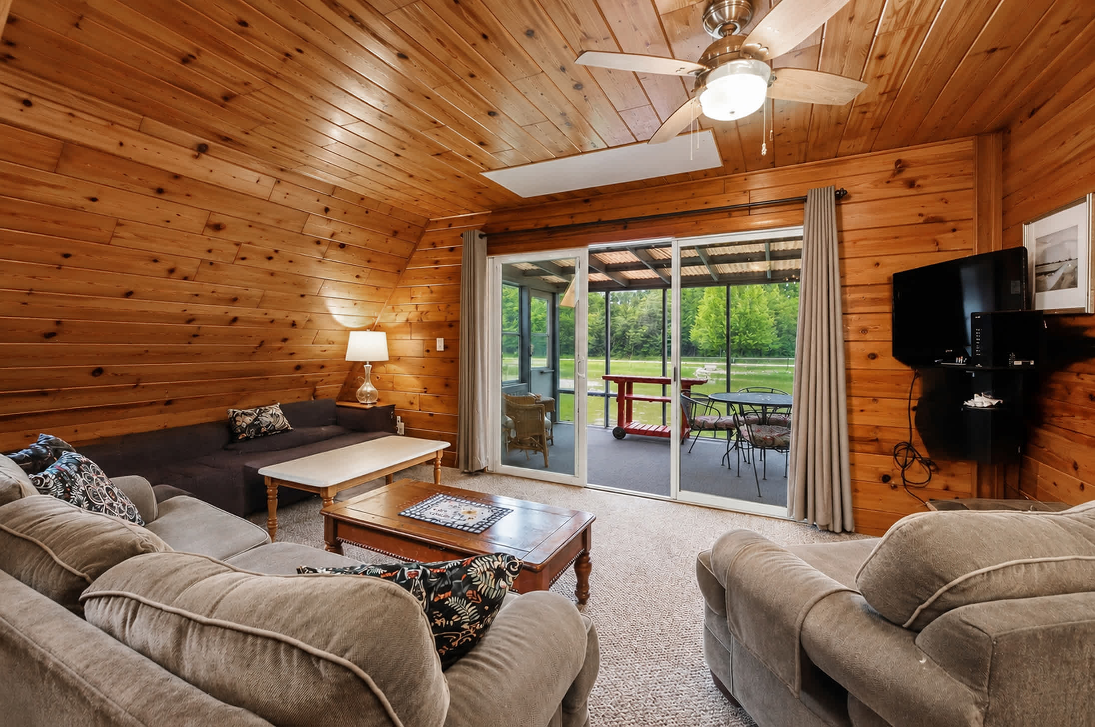 Relax in the living room with seamless access to the screened porch.