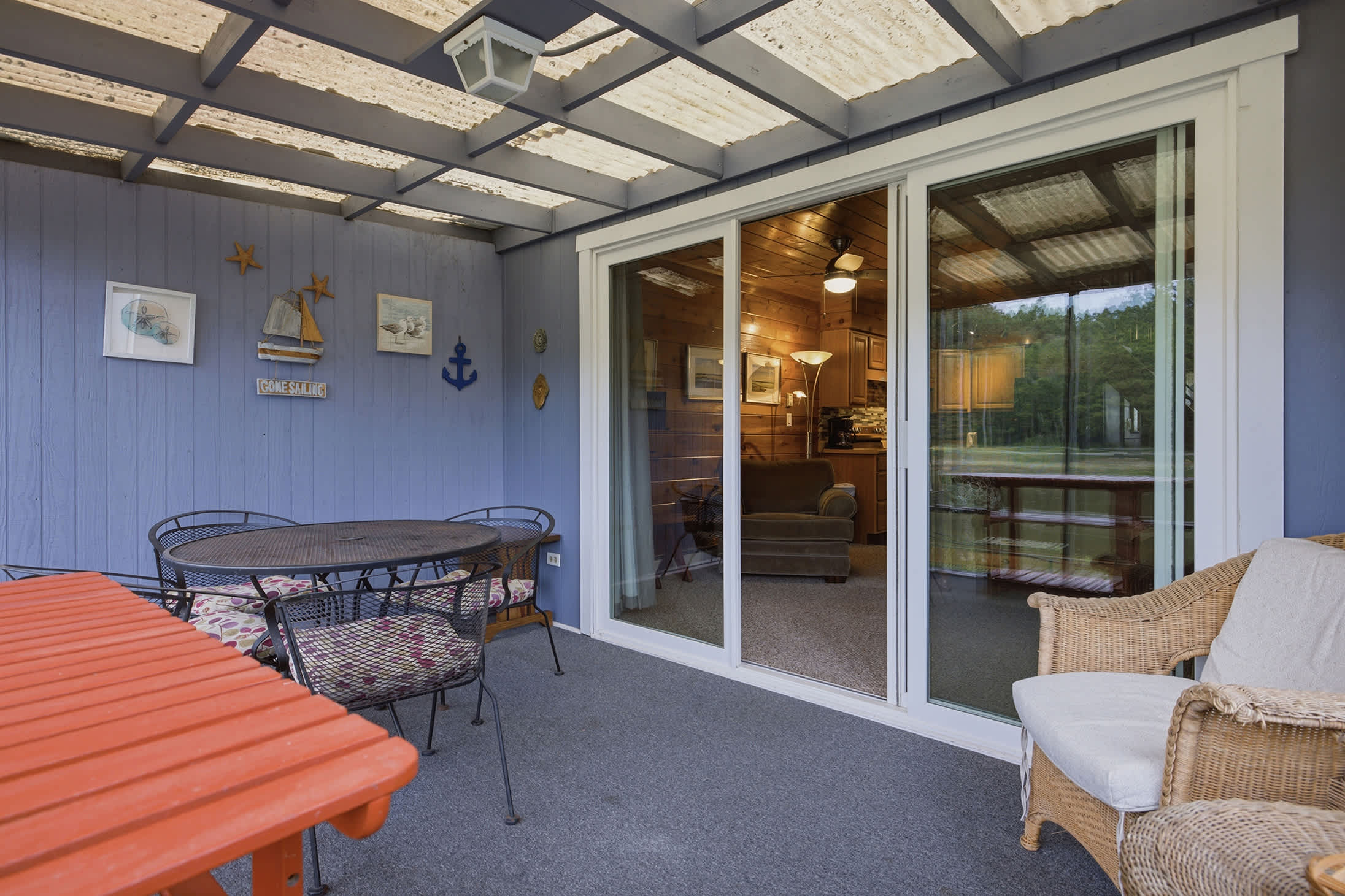 Chalet #93's screened porch extends your living space with peaceful pond views.