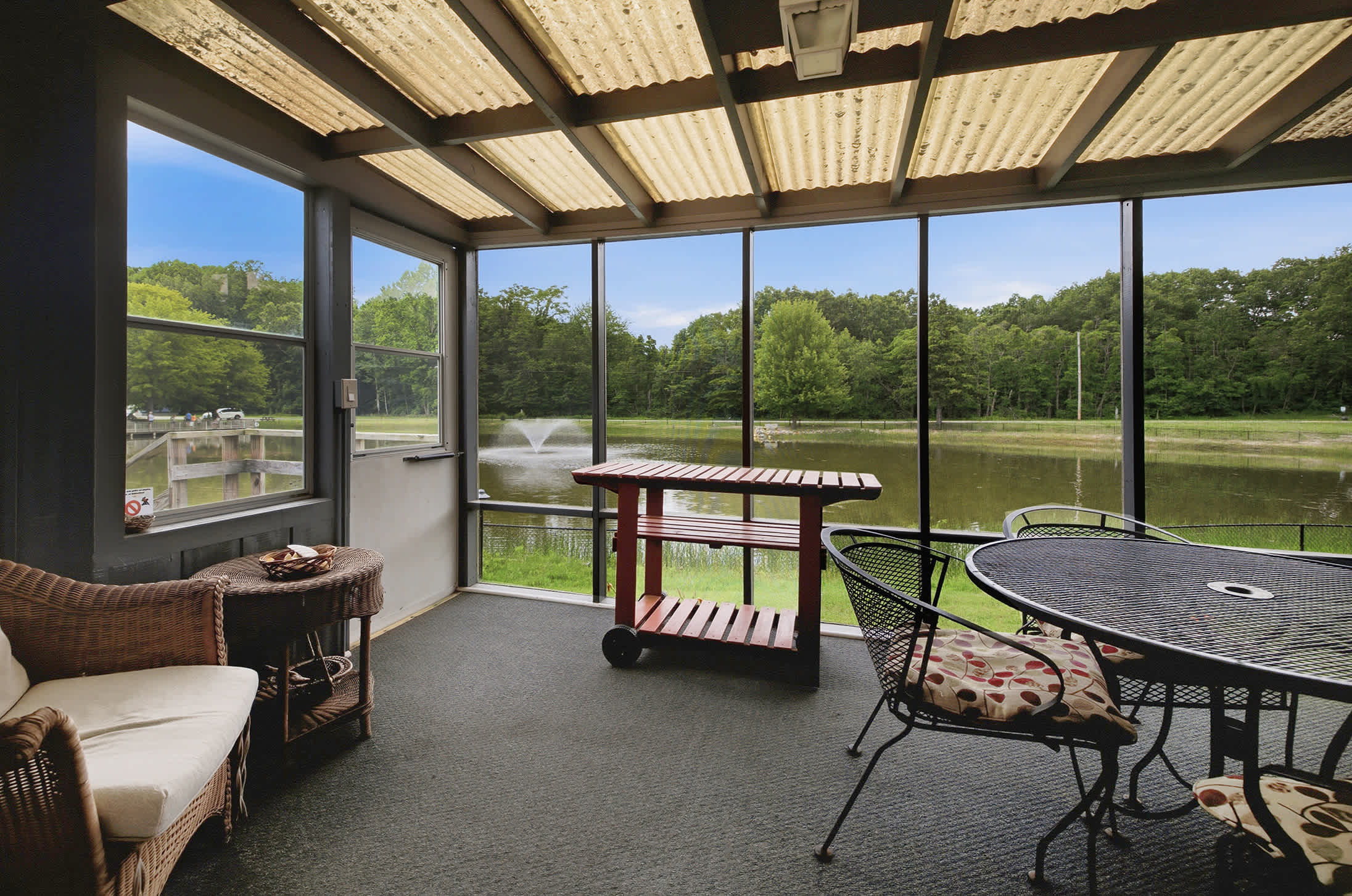 Dine or unwind on the screened porch overlooking the peaceful pond.