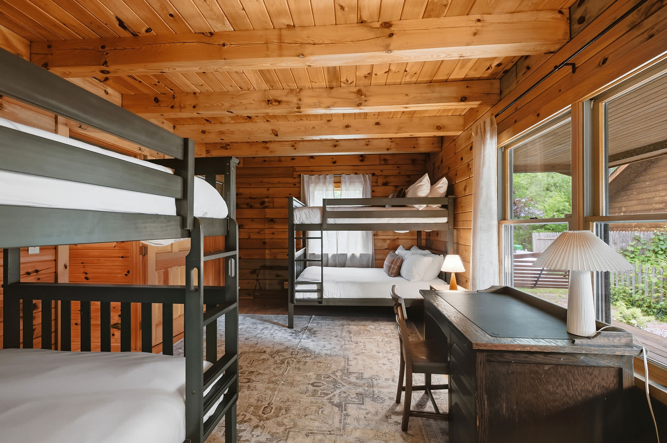 Bedroom 2 is on the main level with 2 full bunkbeds and dedicated workspace.
