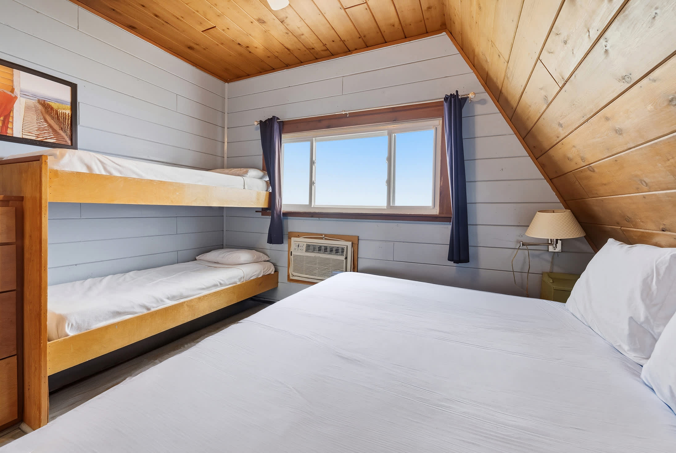 Spacious bedroom with a king bed and built-in bunks for families.