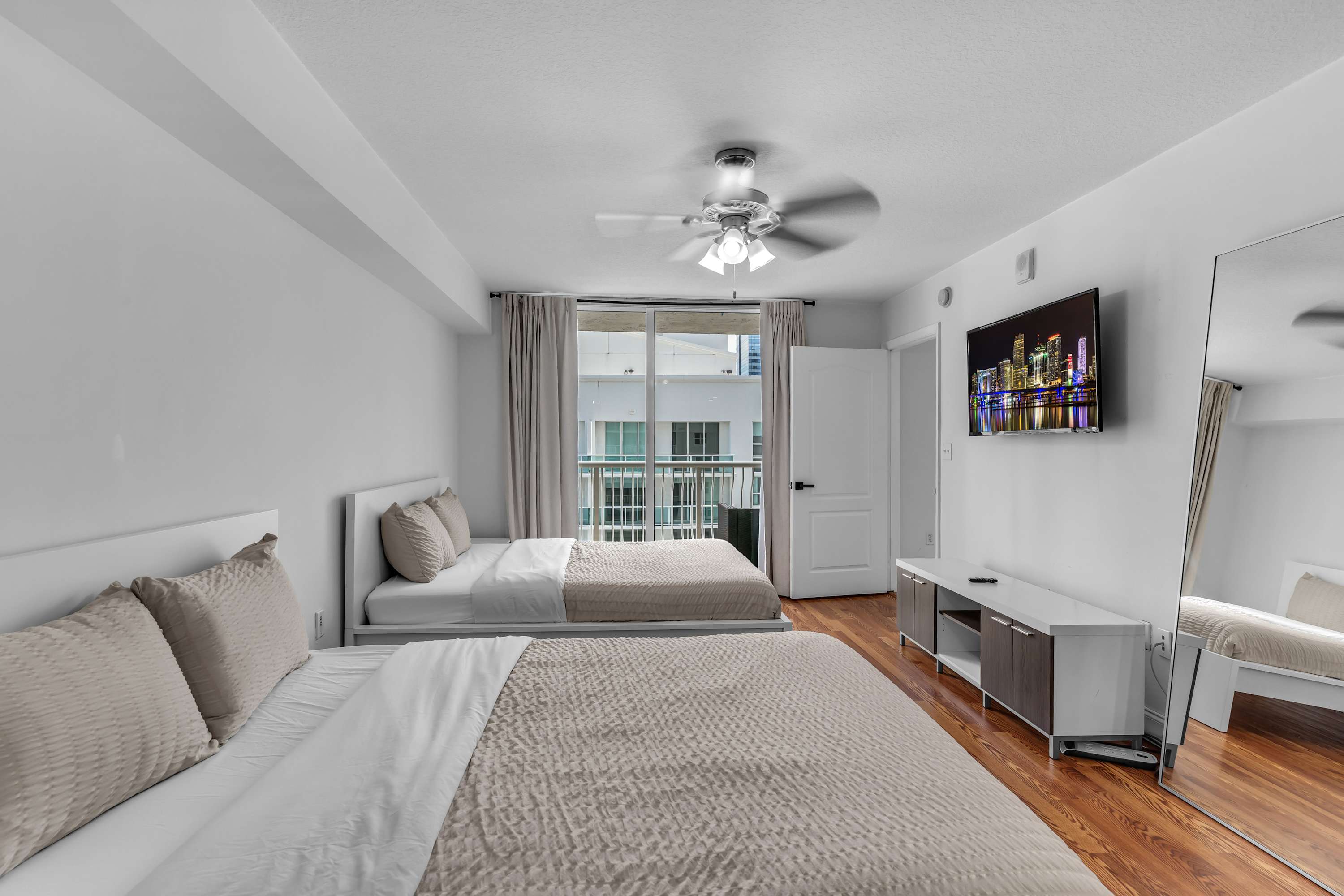 The second balcony suite offers two queen beds, a smart TV, & an ensuite​