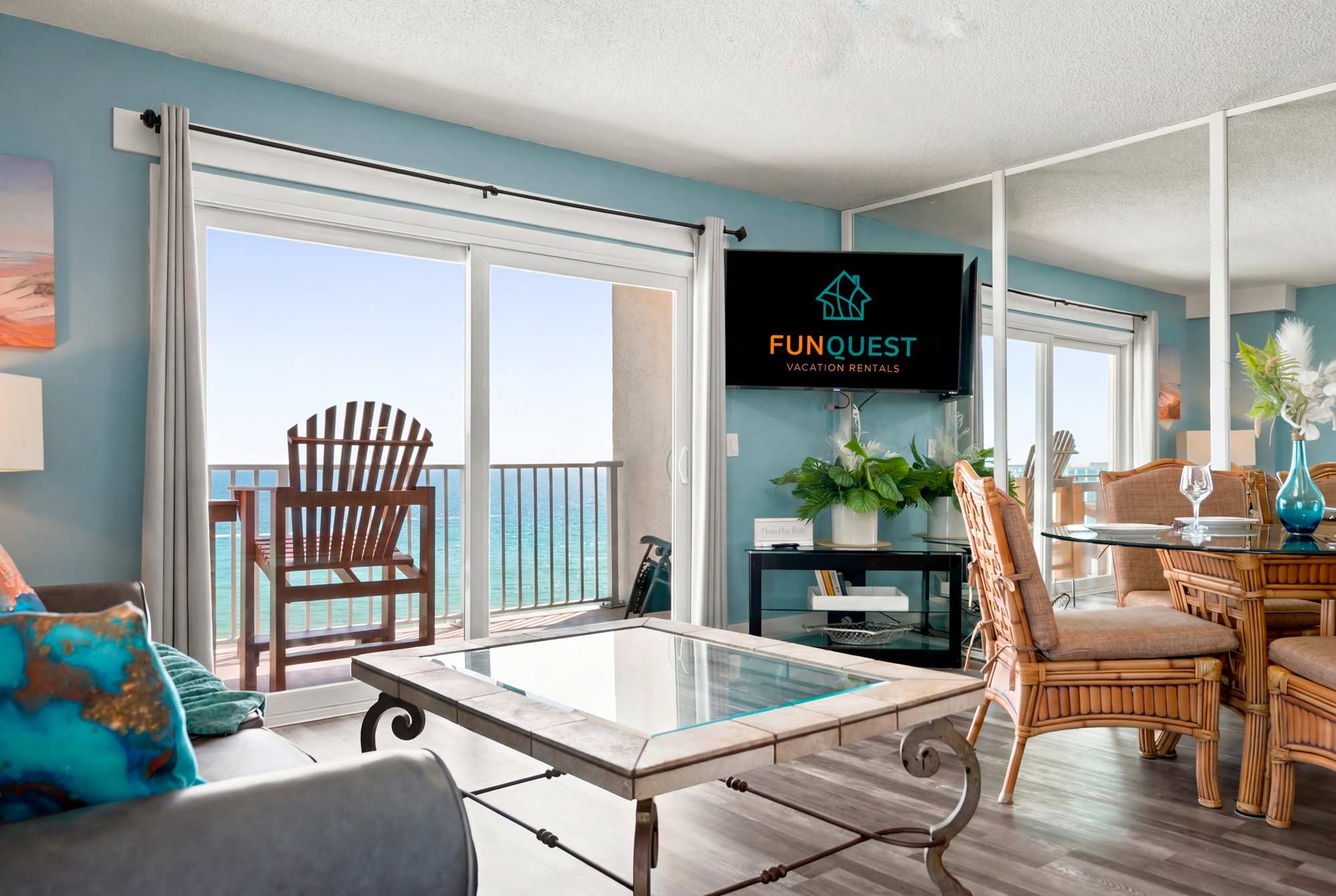 The Summit 1132 – Living room with ocean view, balcony chair, dining area, and flat-screen TV.