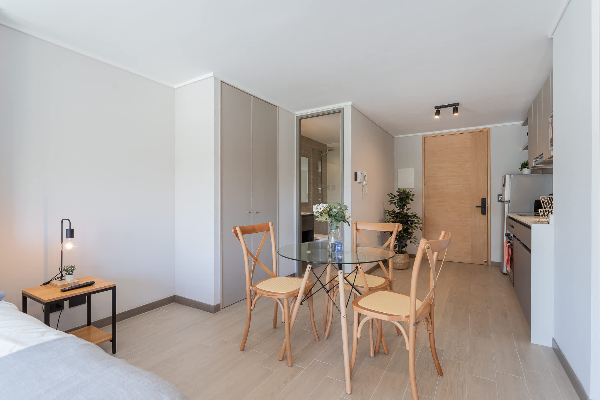 Bright and modern studio with a cozy dining area and sleek kitchenette, perfect for a comfortable stay.