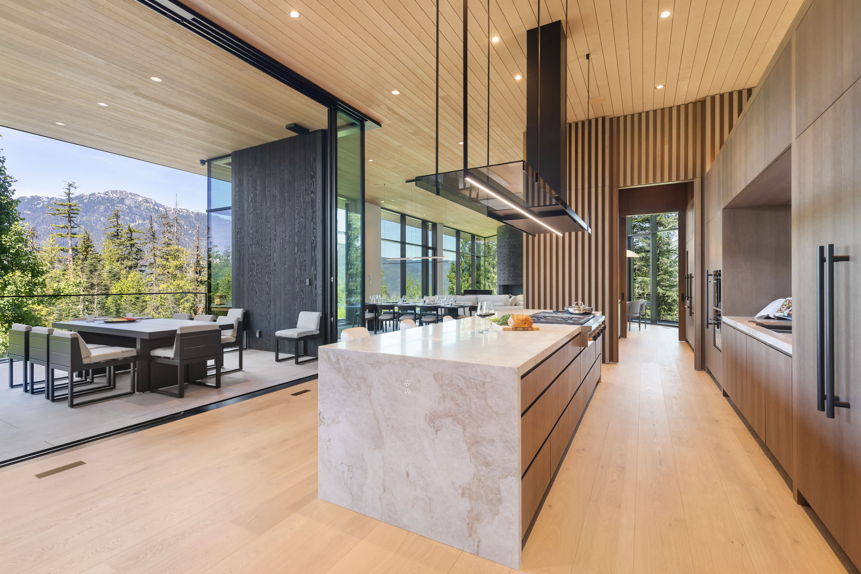 - Modern kitchen overlooking snowy peaks through panoramic glass - Bright open counter designed for scenic meal preparation - Stunning mountain views enhance every cooking moment