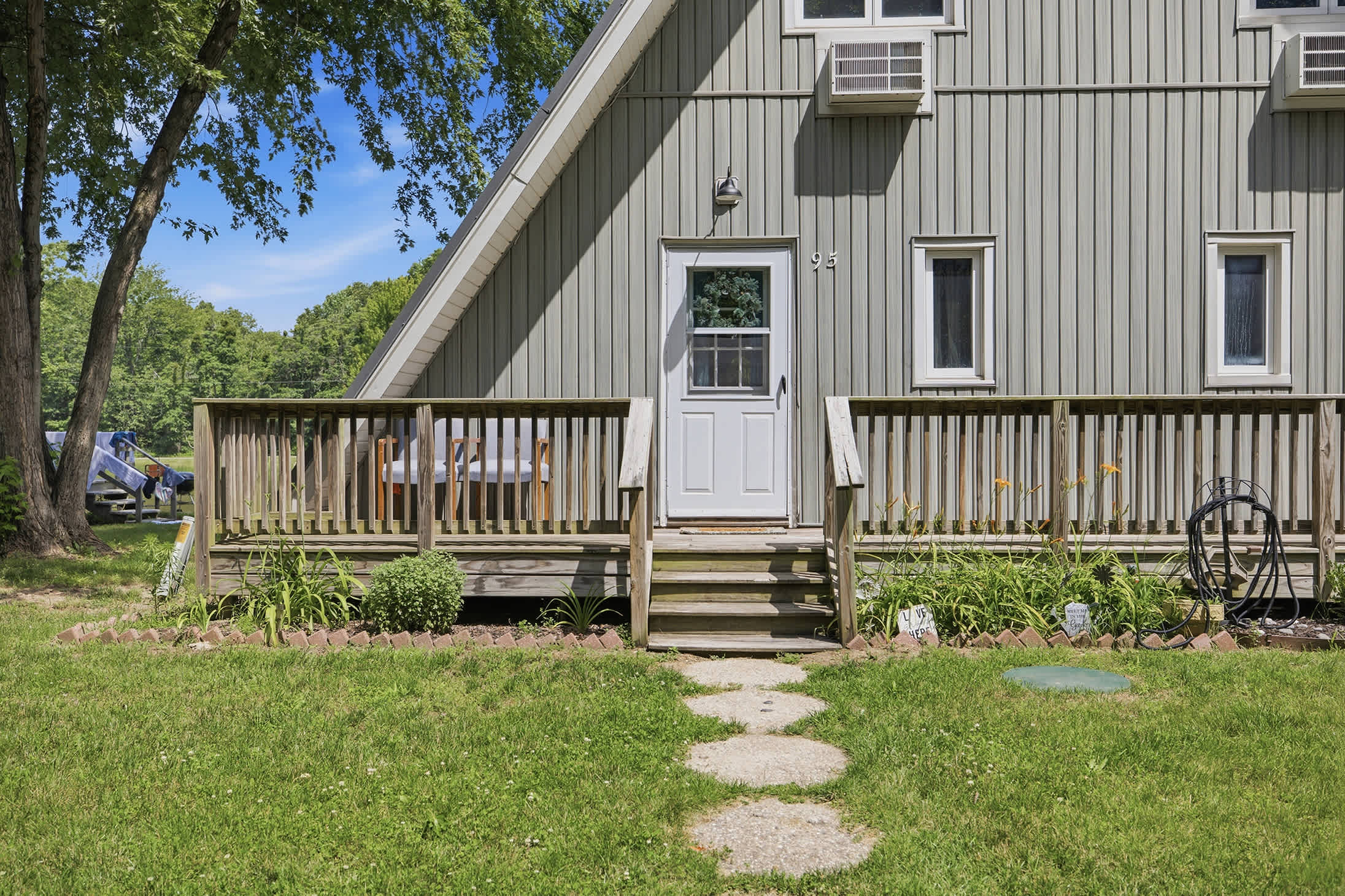 Begin your Harbor Country getaway with a private entrance and outdoor deck at Chalet #95.