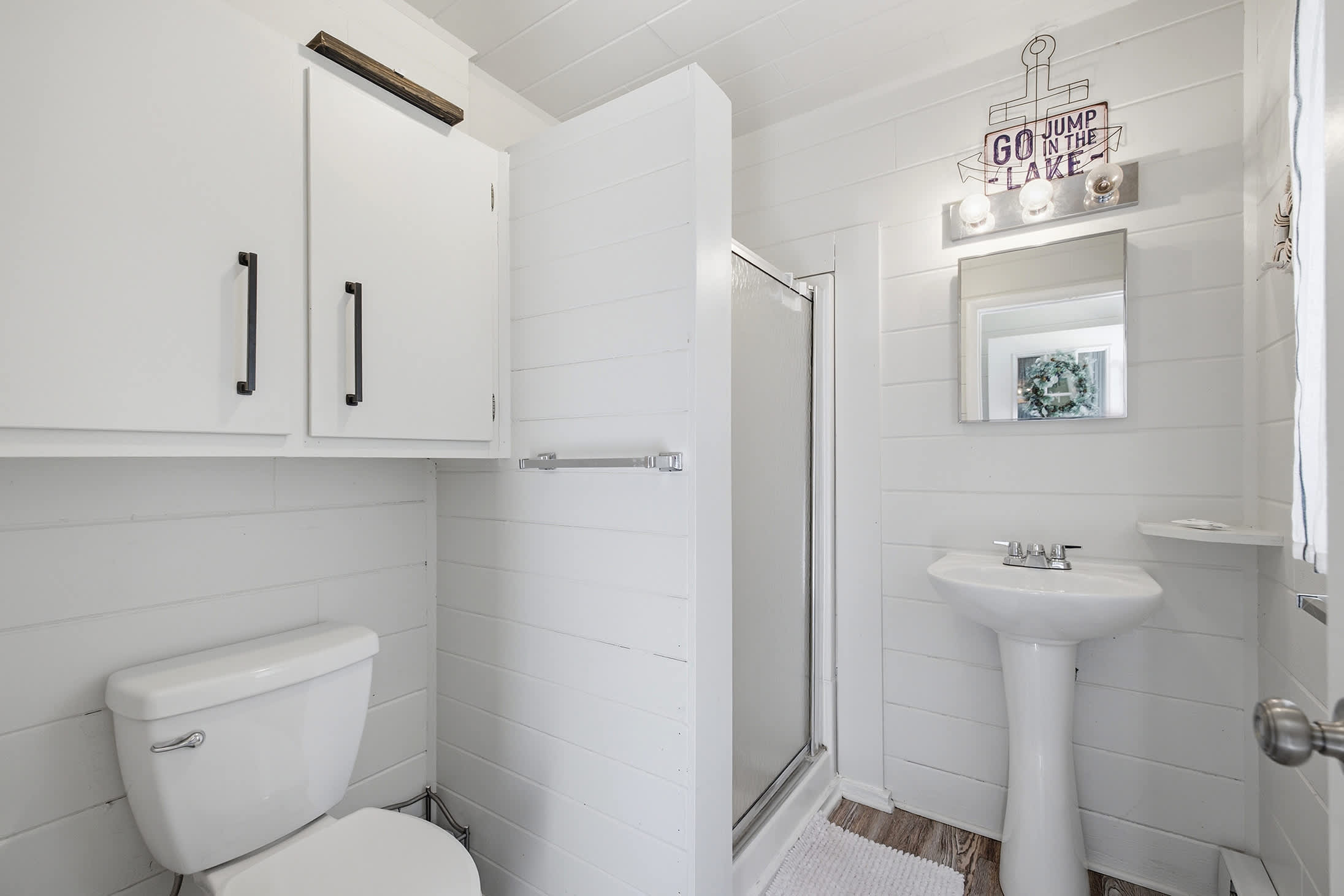 The main floor bathroom features a walk in shower for easy refreshes after the beach or pool.