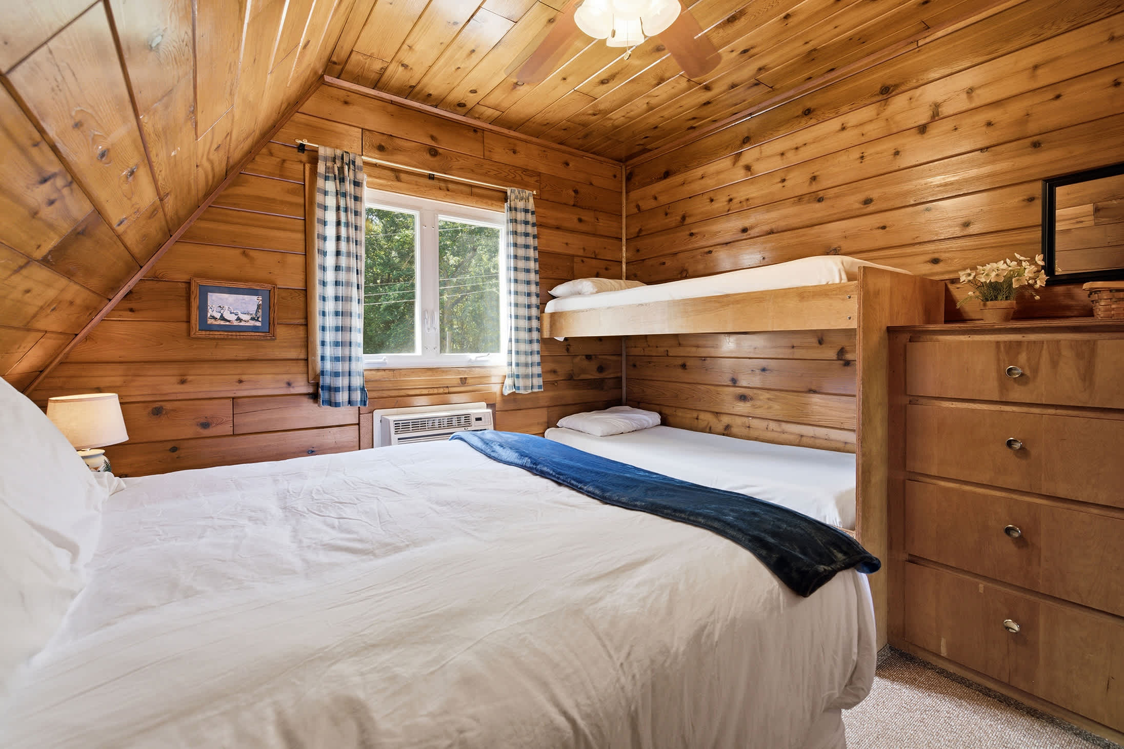 A queen bed and built-in bunks make this room perfect for families or siblings.