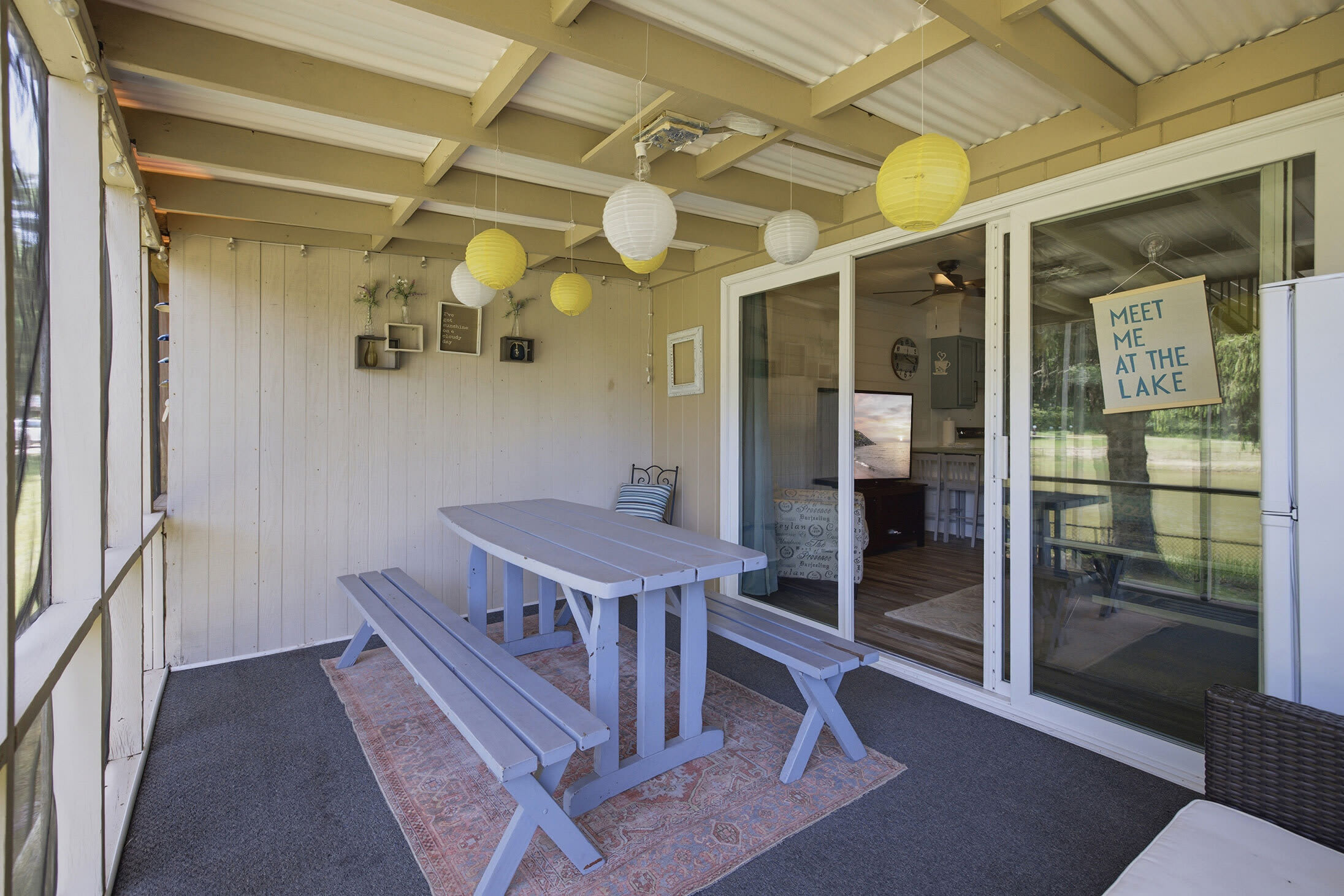 The screened porch offers outdoor dining with peaceful pond views in every season.