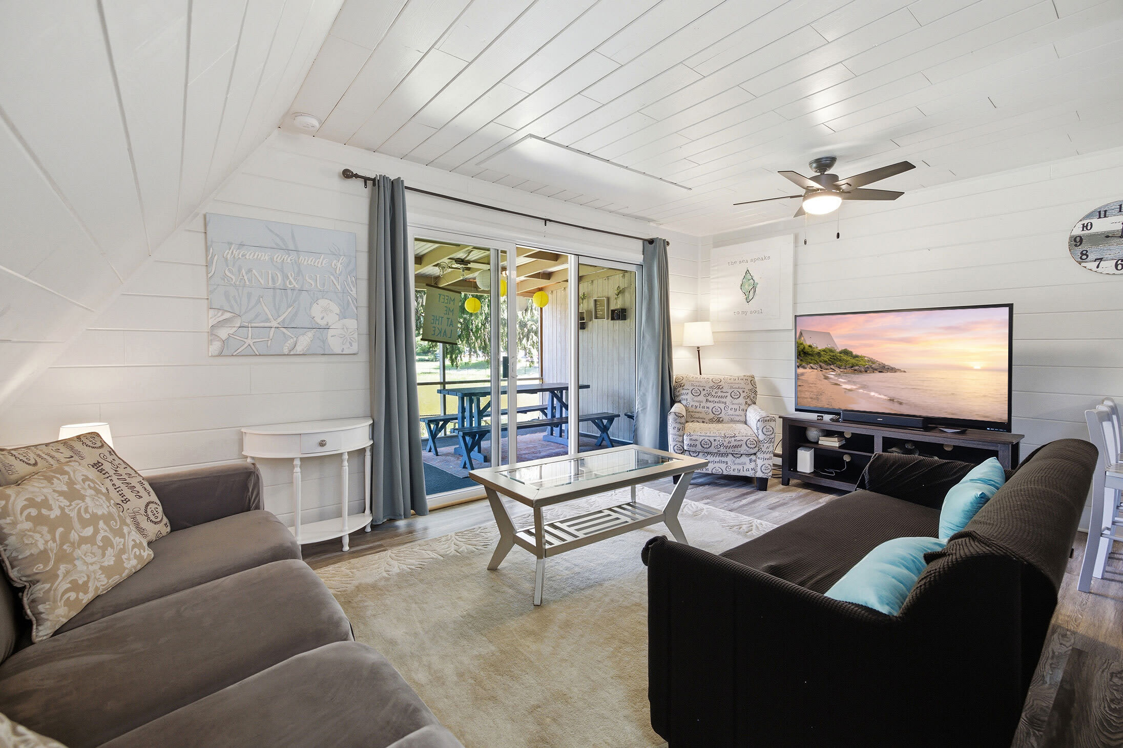 The bright living room connects to the screened porch, extending your space to relax.
