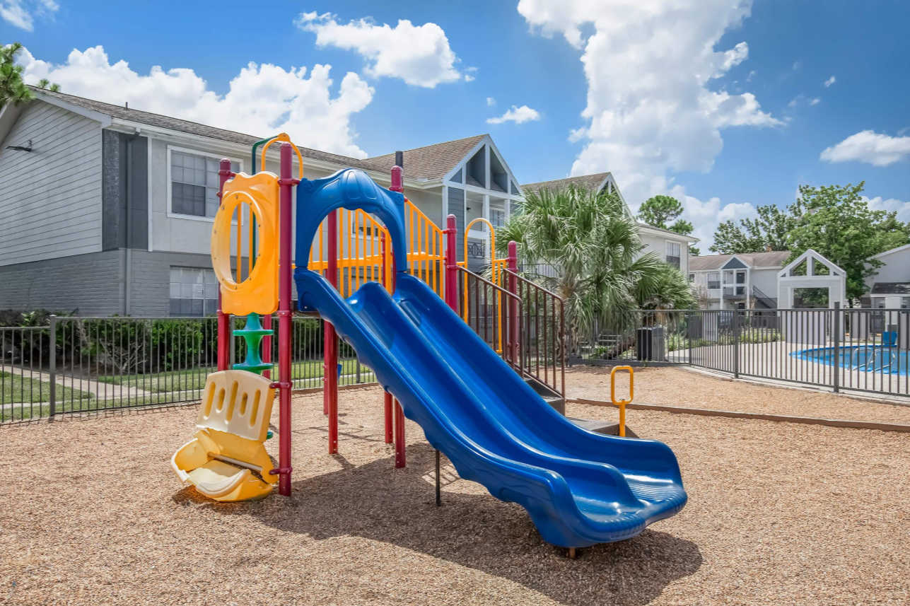 Enjoy family fun at the vibrant playground, perfect for kids to play and explore, with a pool nearby for a refreshing dip.