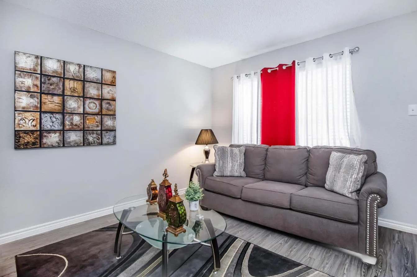 Relax in this stylish living room with a comfy sofa and chic decor, perfect for unwinding after a day of exploring.