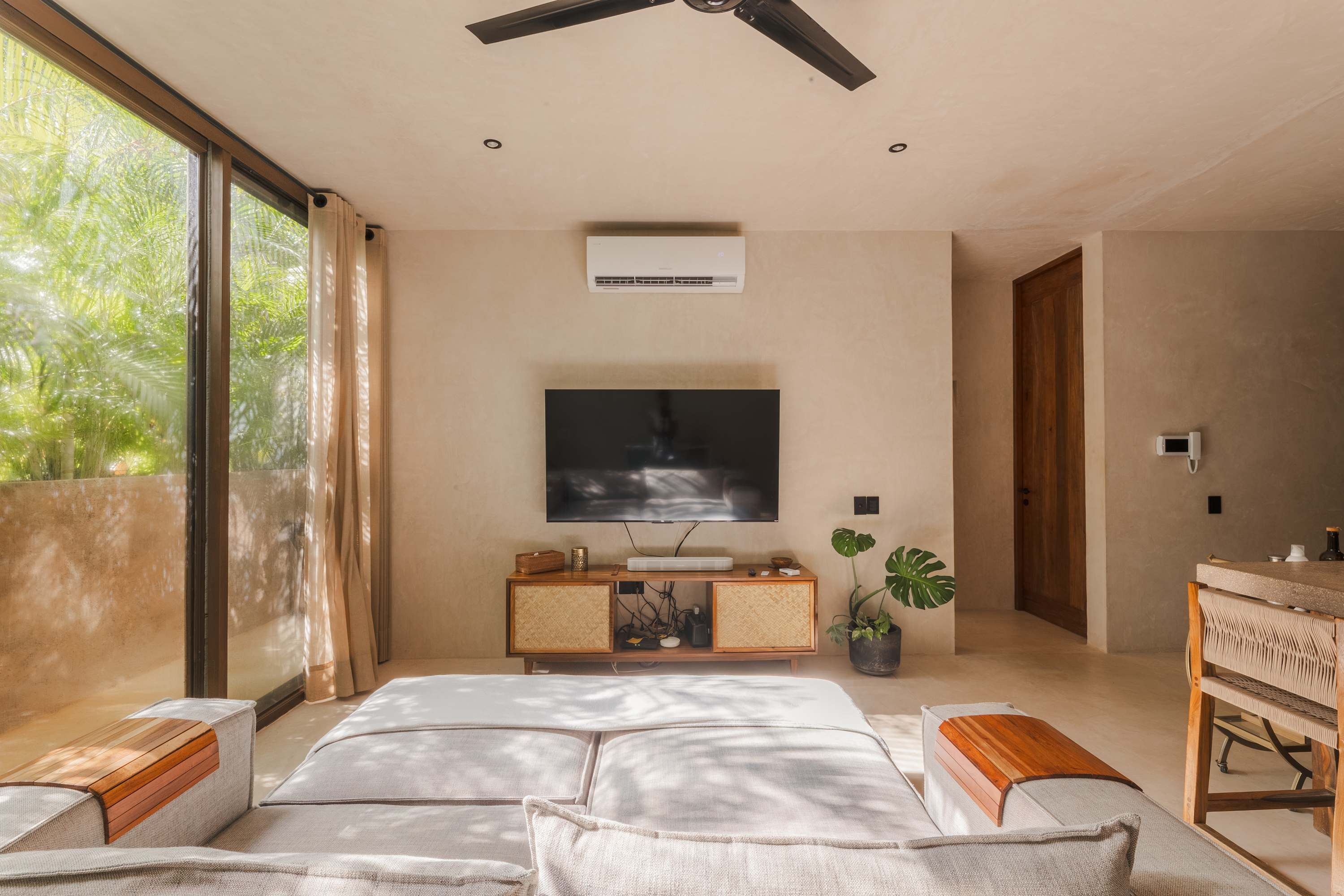 Spacious and bright living room with Smart TV, comfortable seating.