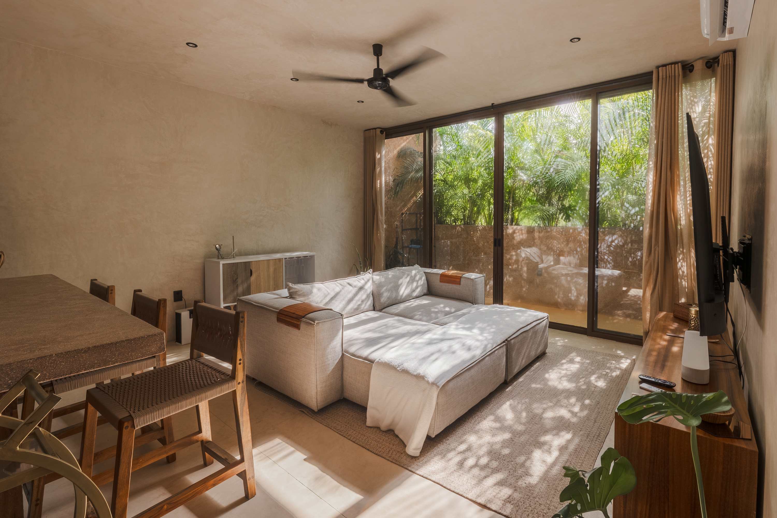Spacious and bright living room with Smart TV, comfortable seating.