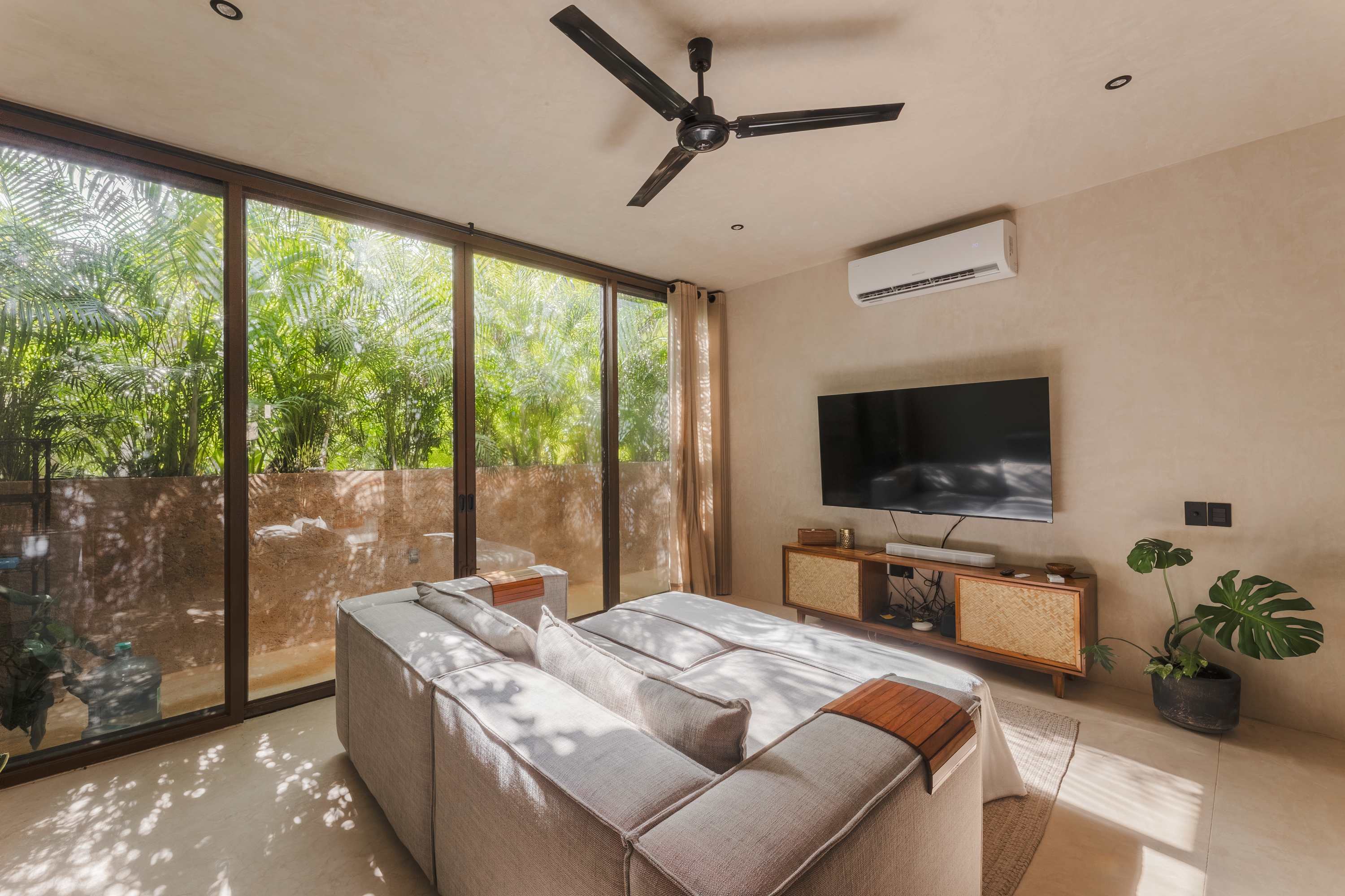 Spacious and bright living room with Smart TV, comfortable seating.