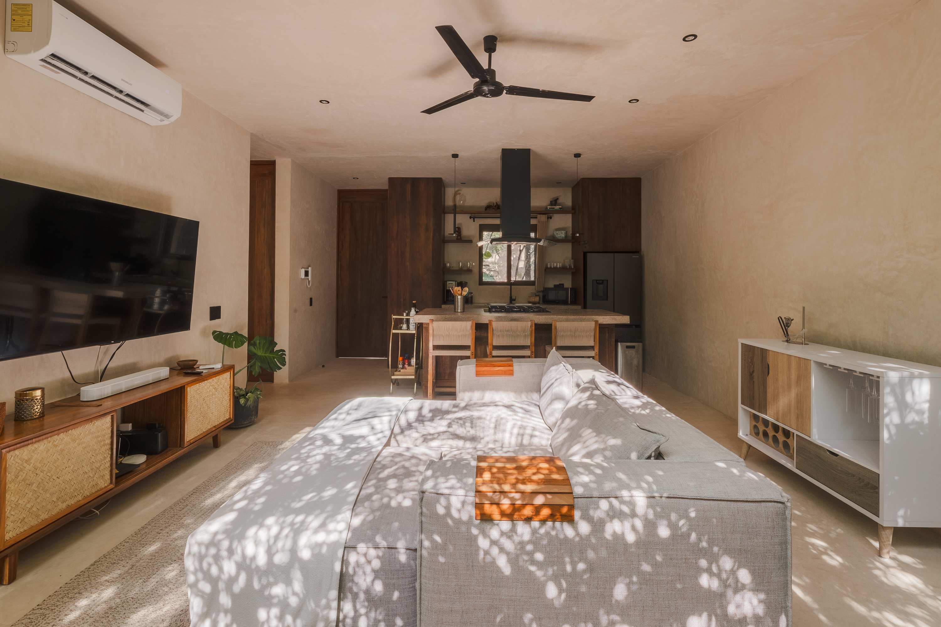 Spacious and bright living room with Smart TV, comfortable seating.