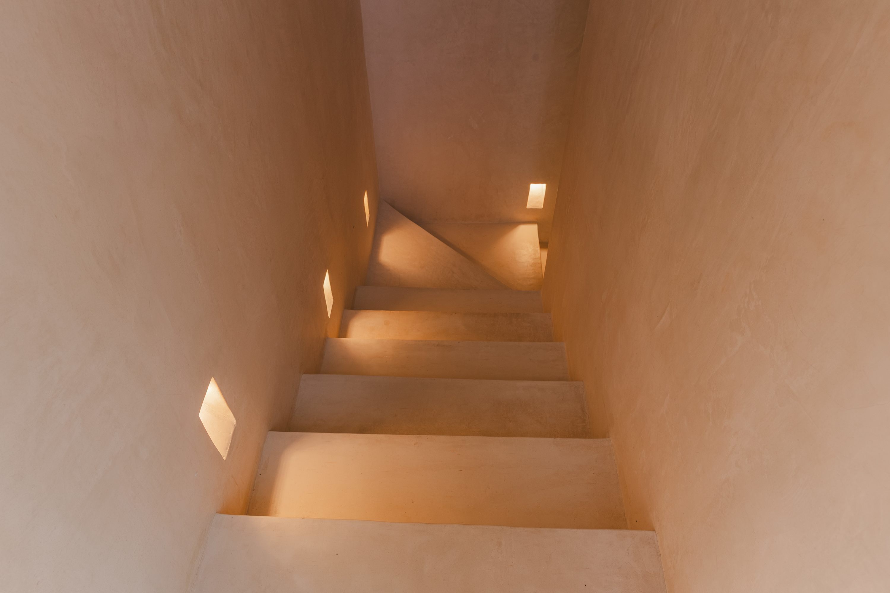 Elegant stairs leading to the second bedroom, adding charm and a sense of privacy to the space.

