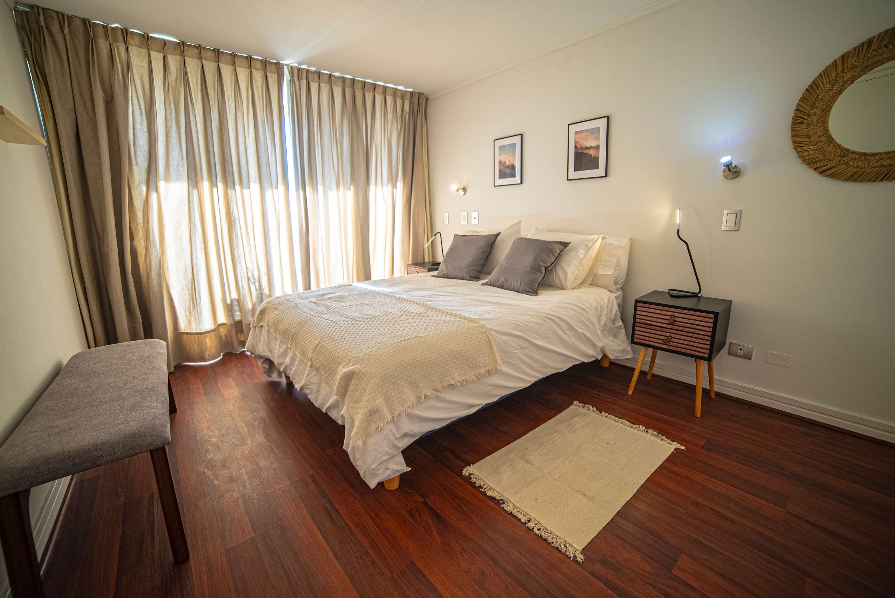 Relax in this cozy bedroom with natural light and stylish decor, perfect for a restful stay in the heart of the city.