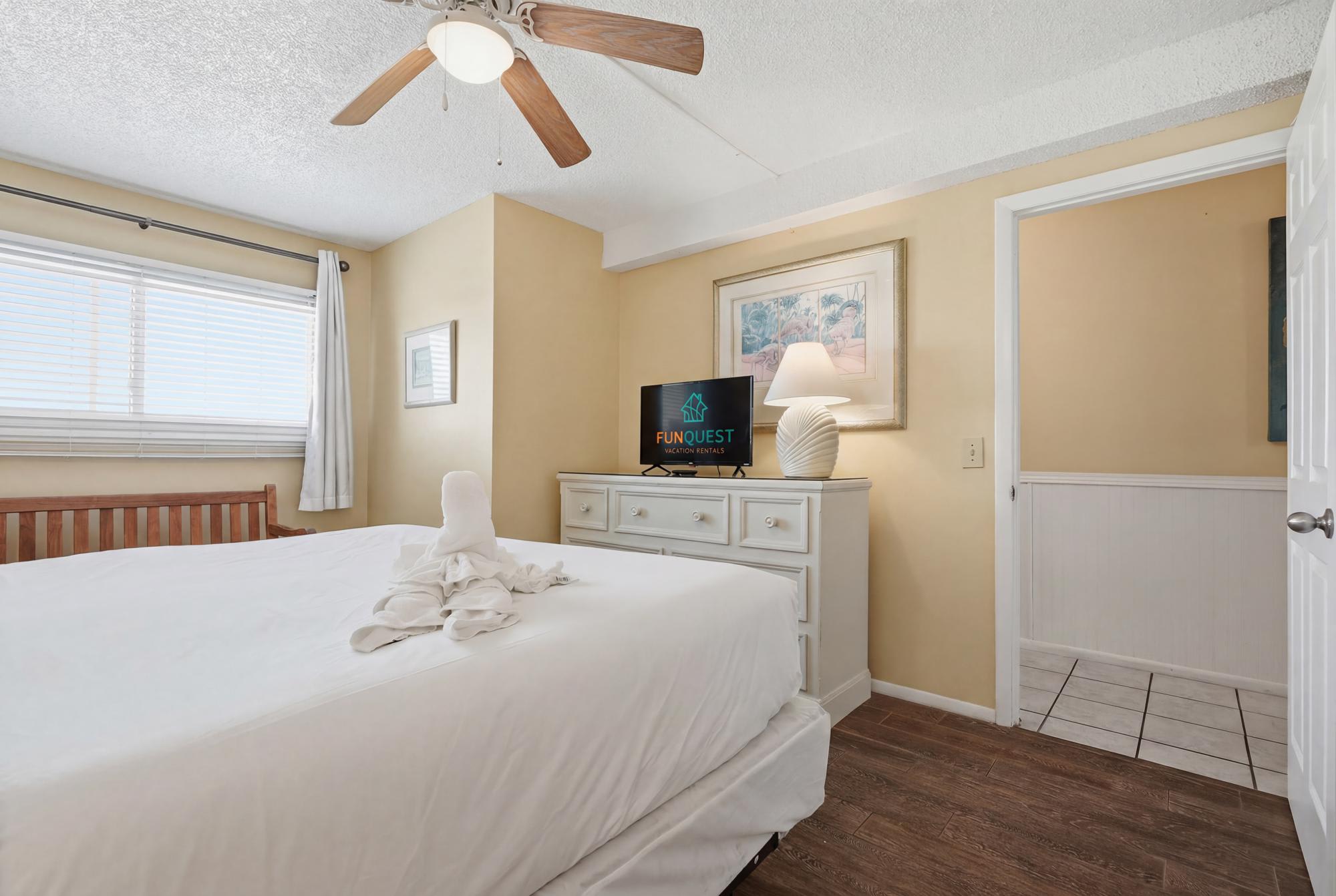The Summit 830 – Cozy bedroom with a king bed, television, and natural light from the window.