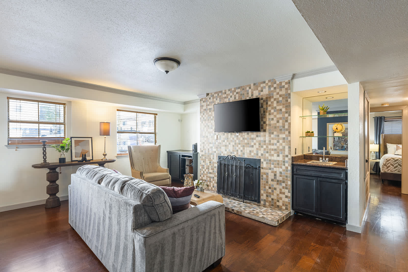 Relax in this inviting living room with a cozy fireplace and modern TV setup, perfect for unwinding after a day of exploring.