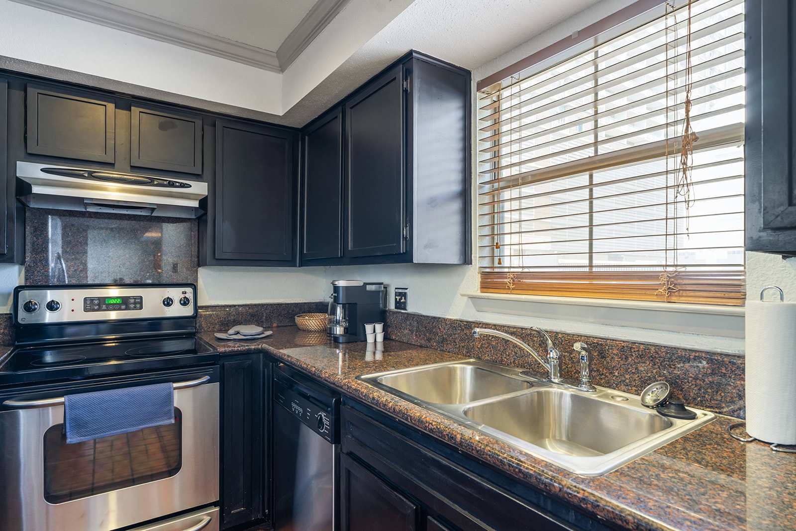 Modern kitchen with sleek appliances and ample natural light, perfect for culinary adventures.