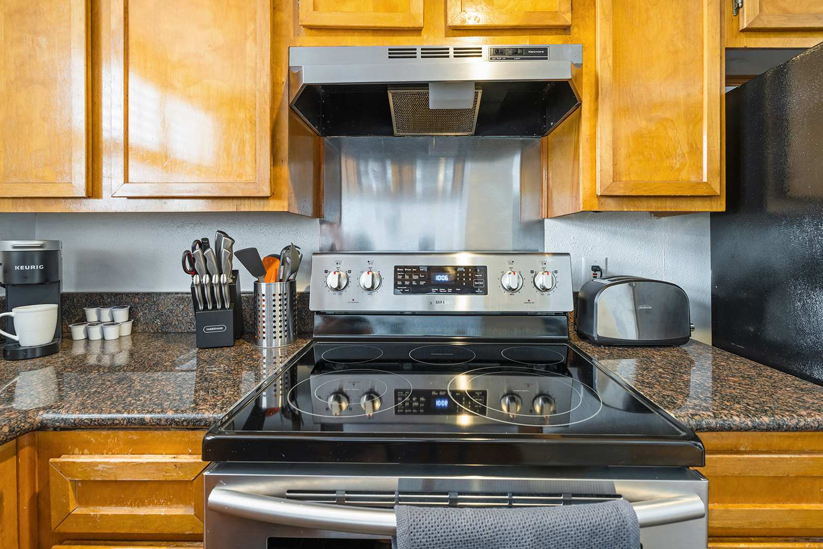 Modern kitchen with stainless steel appliances and granite countertops, perfect for cooking and enjoying meals together.