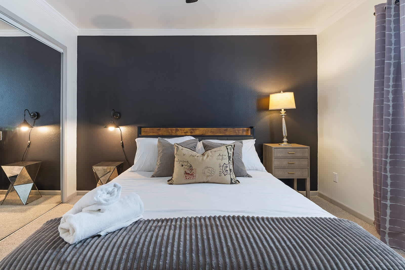 Relax in this stylish bedroom with a plush bed and modern decor, perfect for a restful night's sleep.