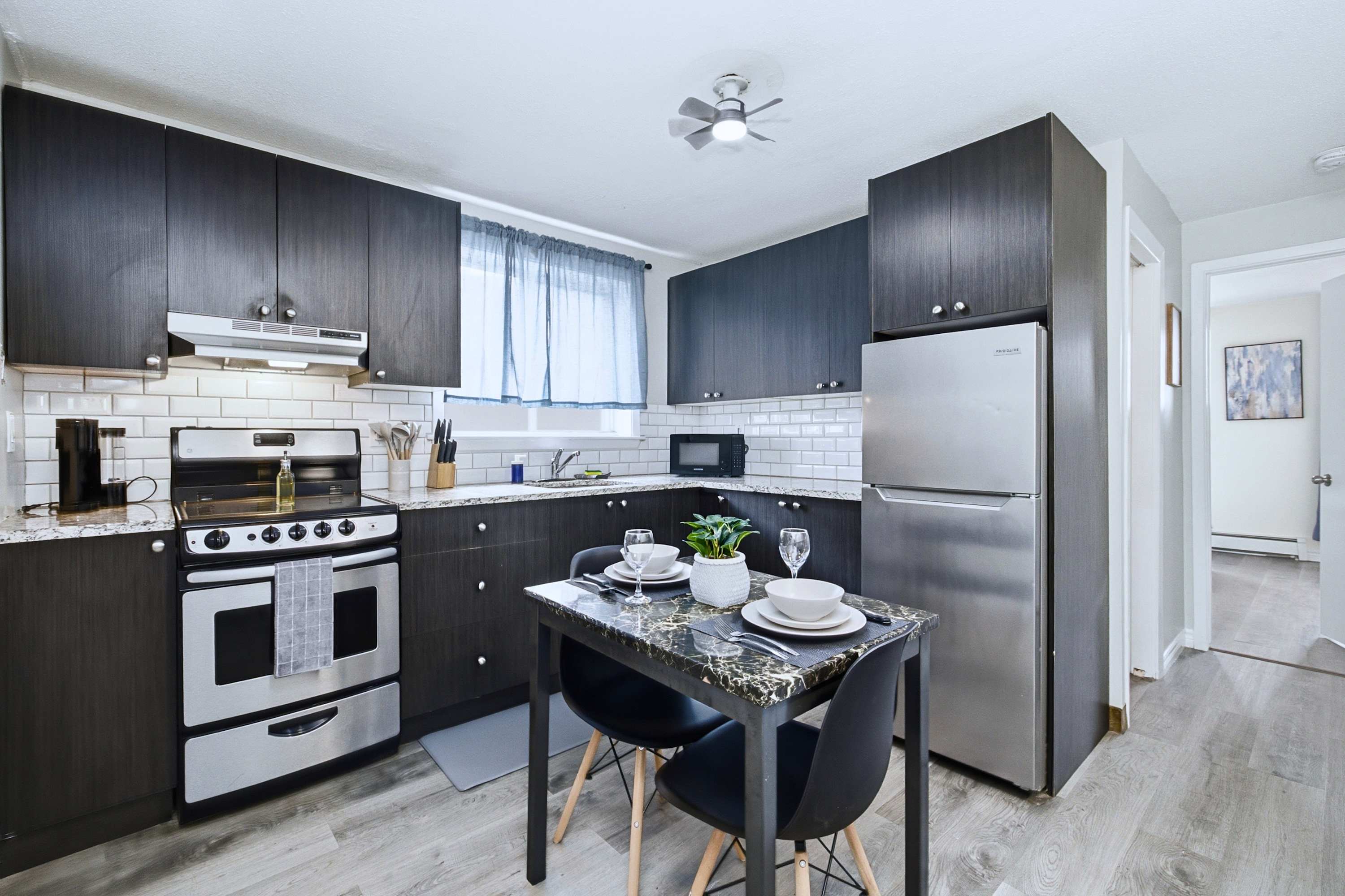 Cook with ease and share meals together at the inviting dining table for two