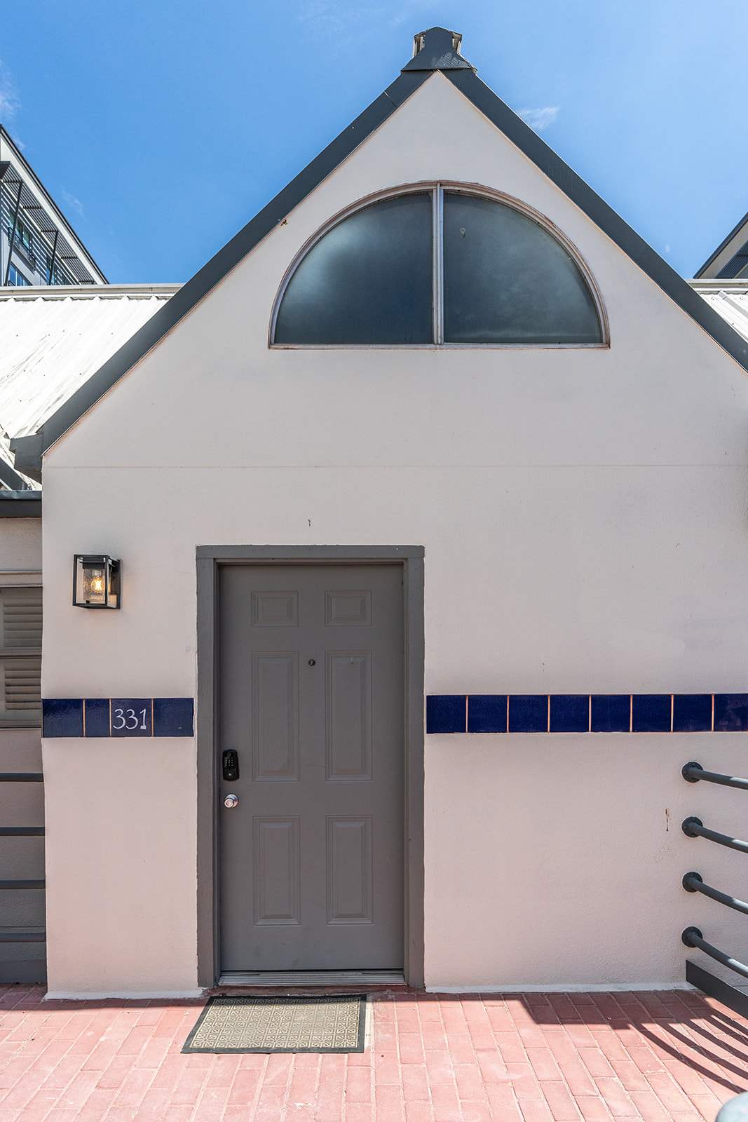 Charming entrance with unique architectural features and vibrant blue accents, perfect for your stay.