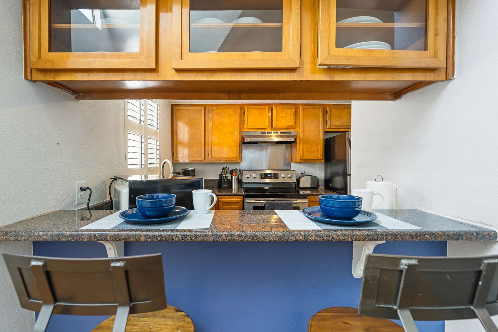 Cozy kitchen with bar seating, perfect for casual dining and morning coffee.
