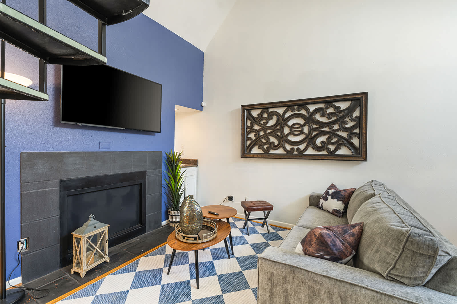 Cozy living room with stylish decor, a fireplace, and a wall-mounted TV, perfect for relaxation and entertainment.