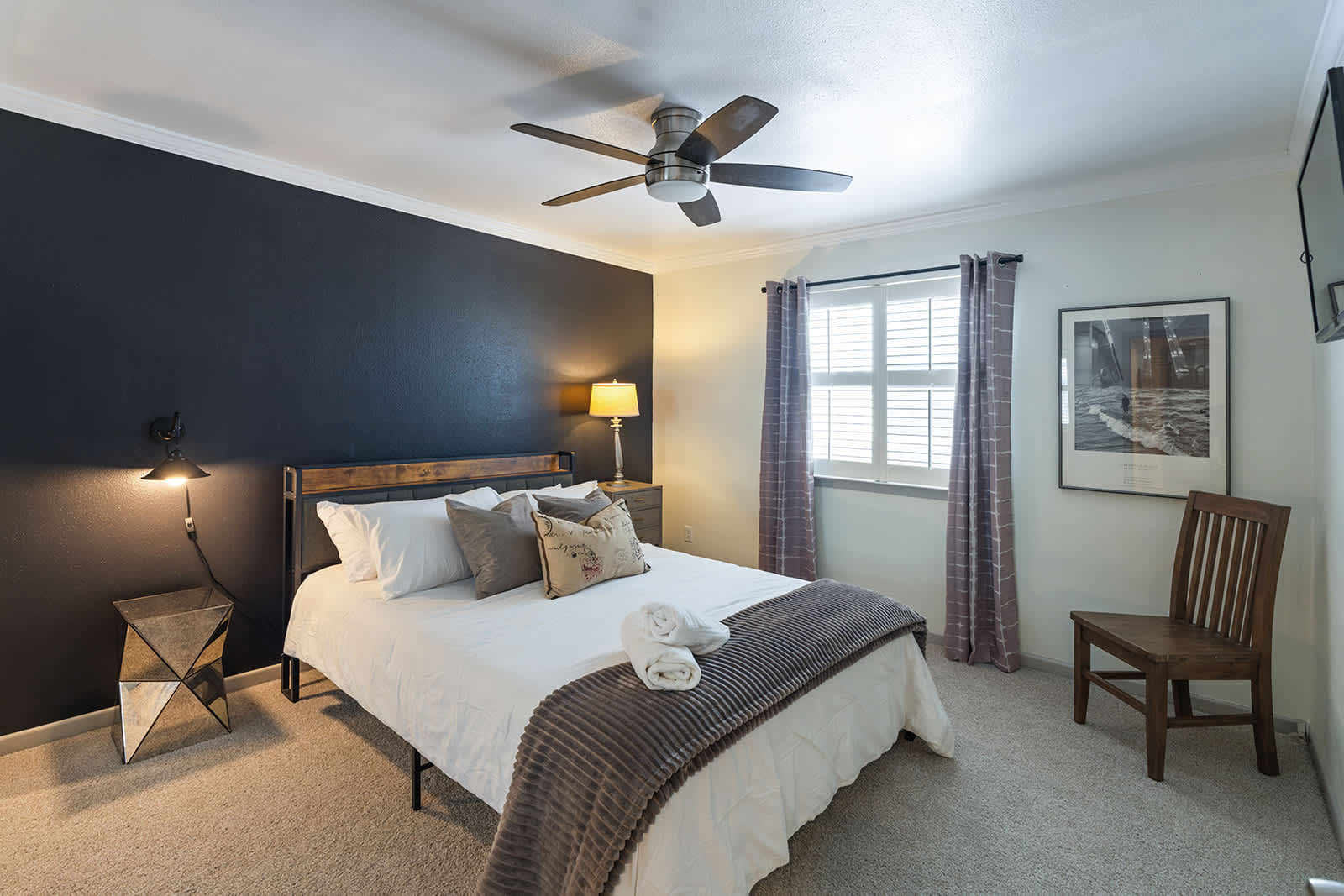 Cozy bedroom with stylish decor, comfortable bedding, and ample natural light—perfect for a restful stay.