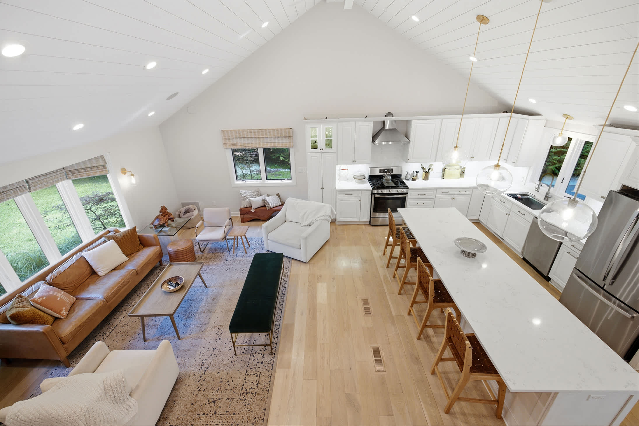 A sweeping view of the home’s warm, welcoming living and kitchen spaces.