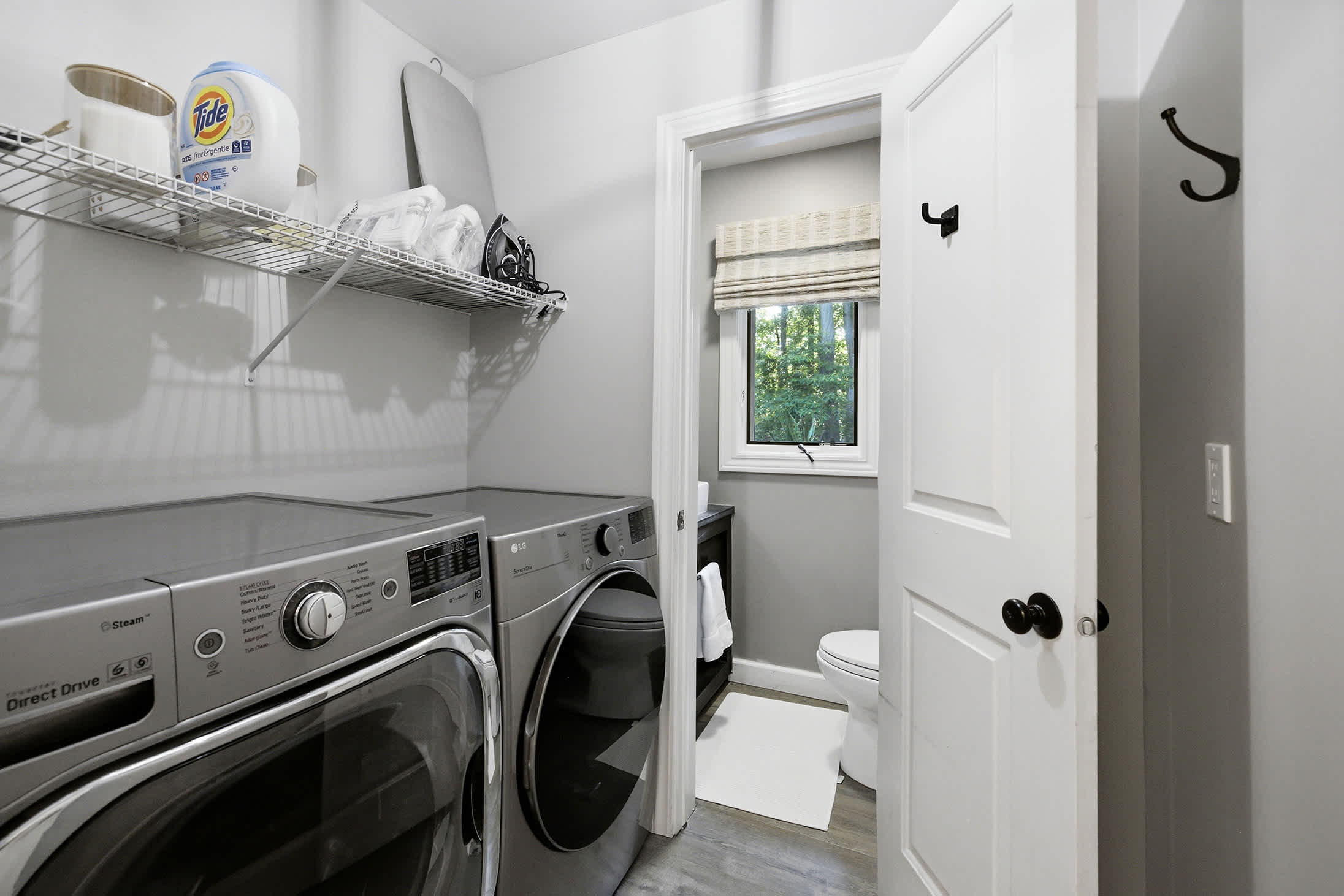 Our tidy laundry space has a bonus half bath for added convenience.