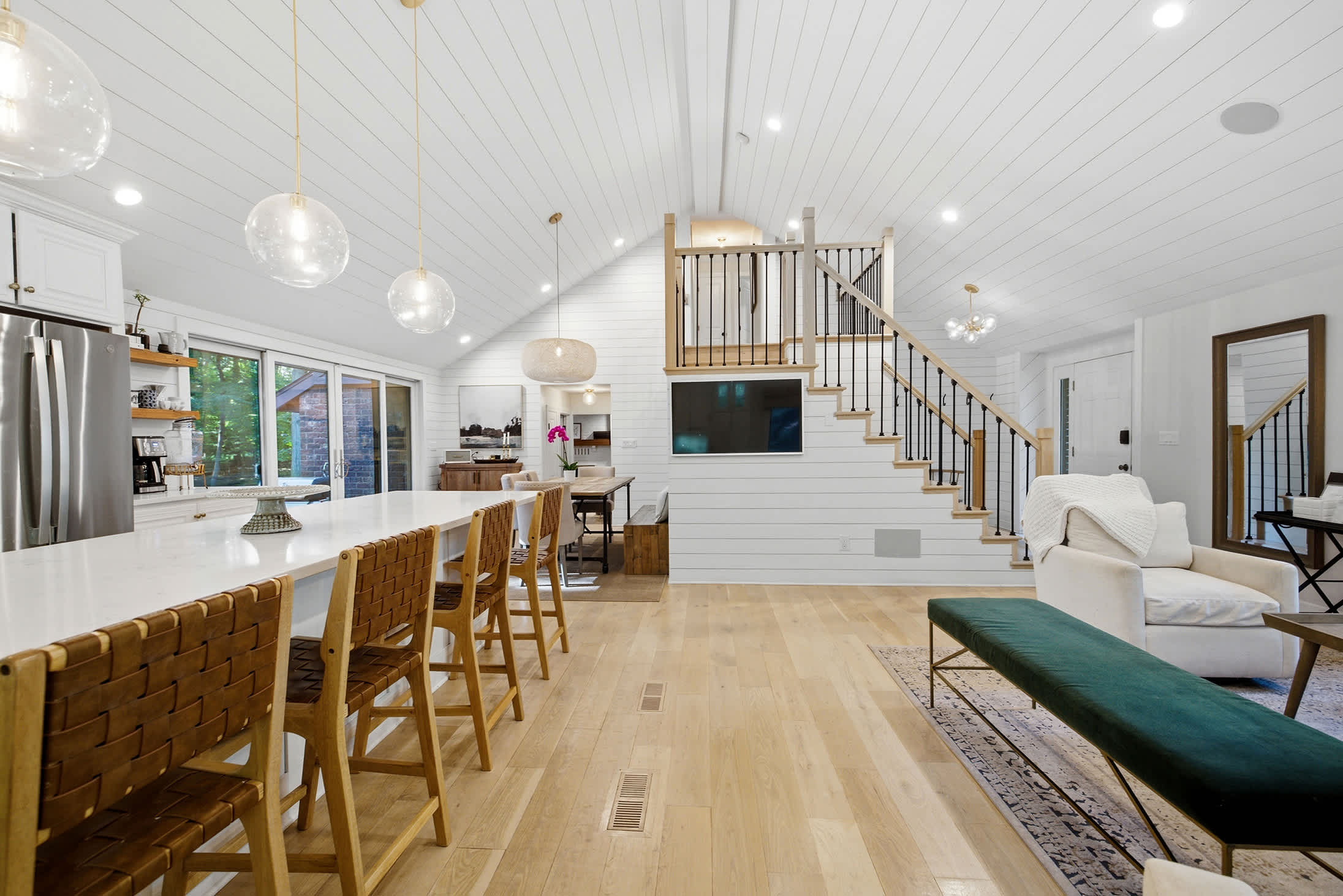 Open sightlines from kitchen to lounges make hosting seamless.