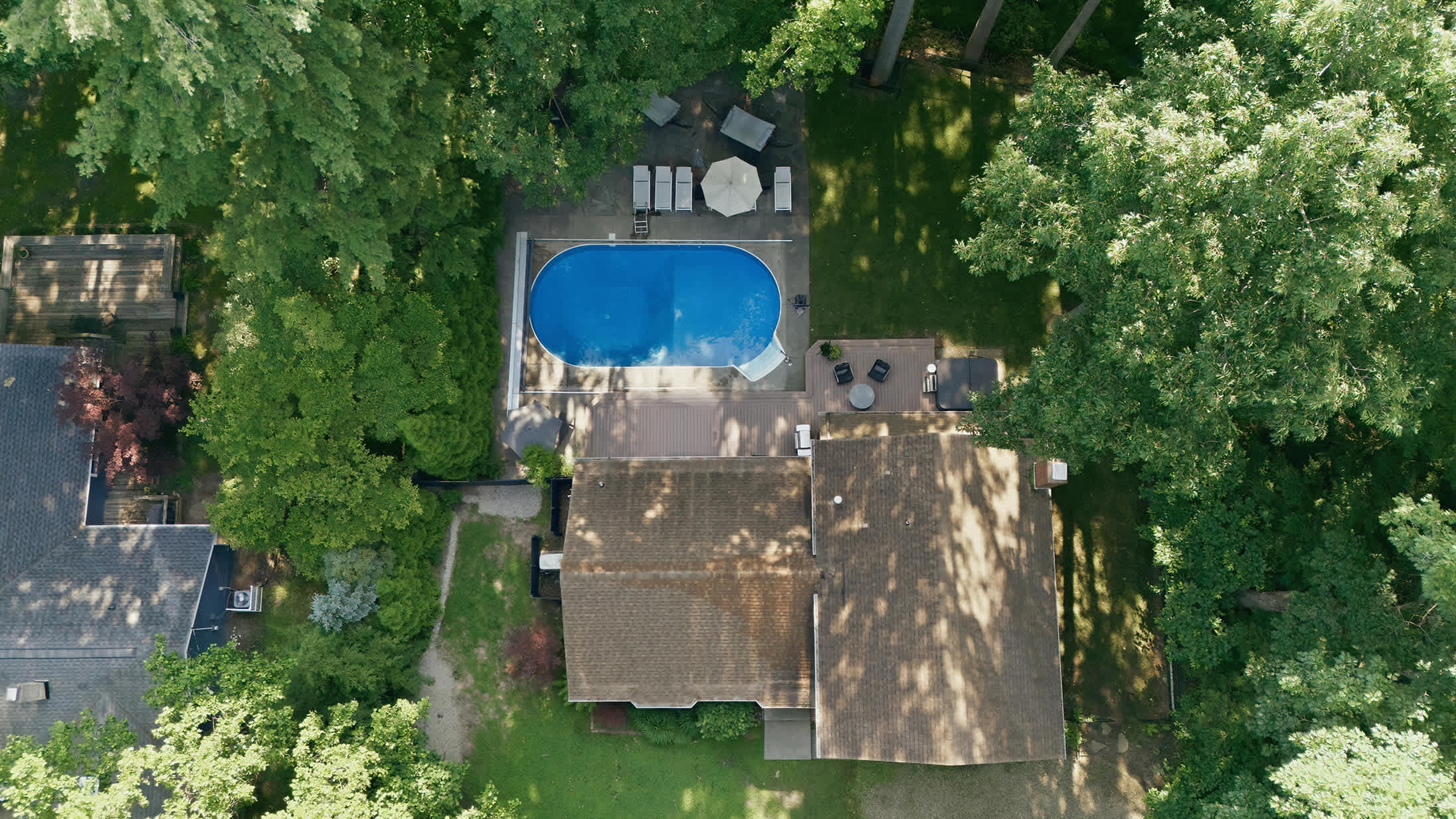 See it all from above with a private pool, expansive deck, and wooded surroundings.