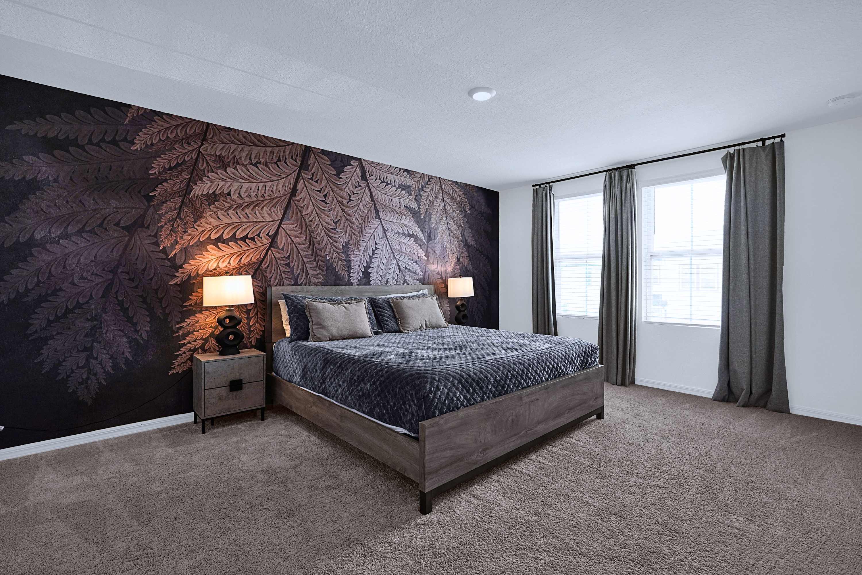 Beautifully designed bedroom with a luxurious king bed and warm bedside lighting