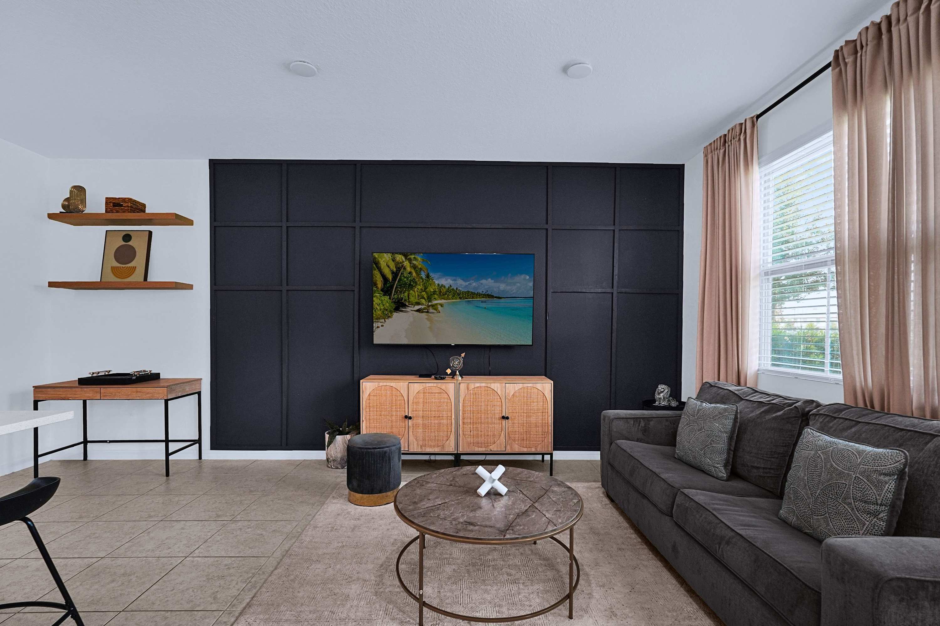 A welcoming retreat featuring a cozy sofa, ambient lighting, and modern interiors