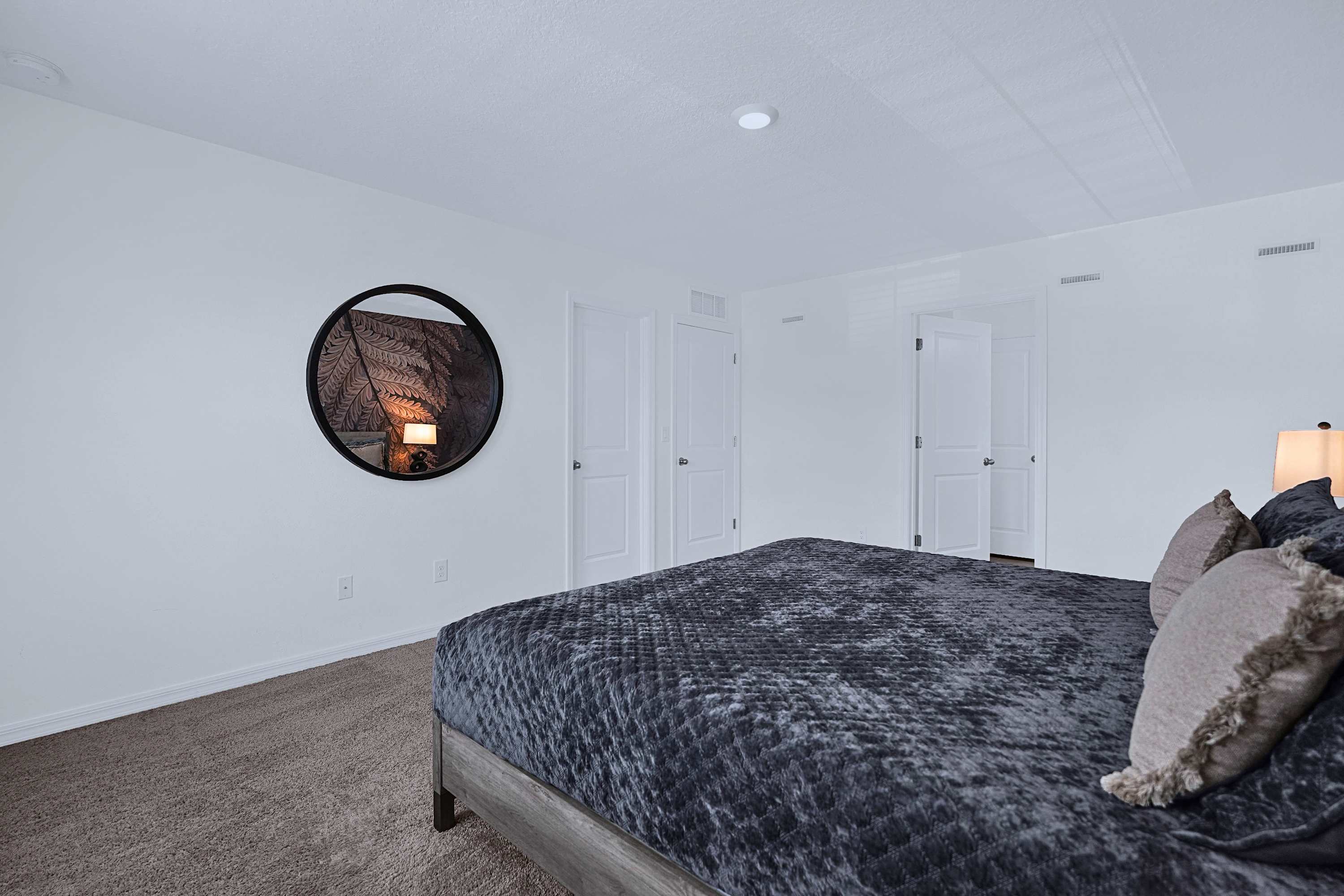 Beautifully designed bedroom with a luxurious king bed and sophisticated wall feature