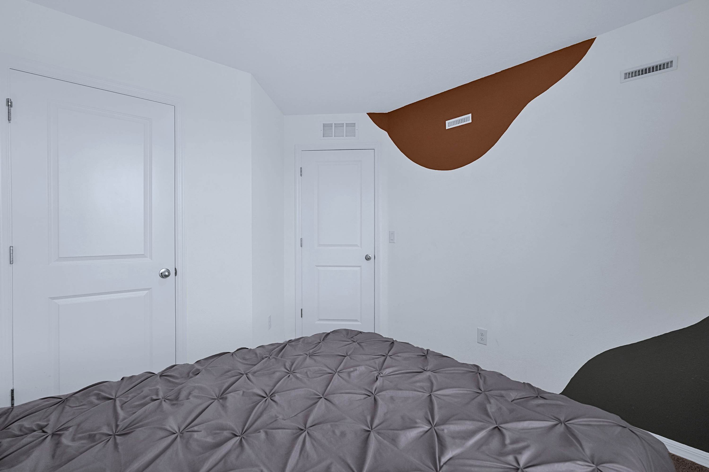 Elegant bedroom retreat featuring a queen bed, fresh linens, and stylish side lamps