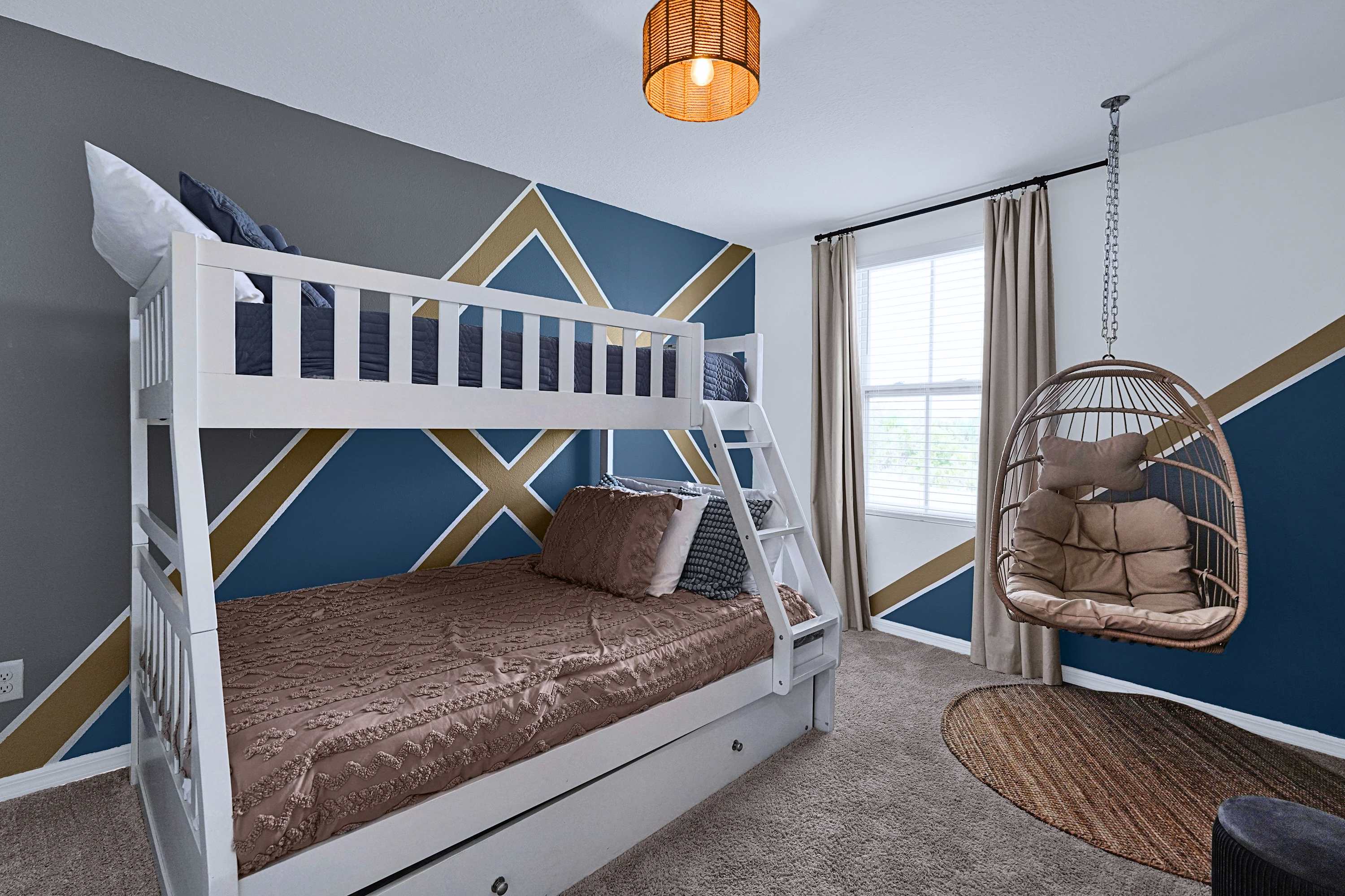 Relax in a unique bunk area featuring cozy beds and a hanging hammock retreat