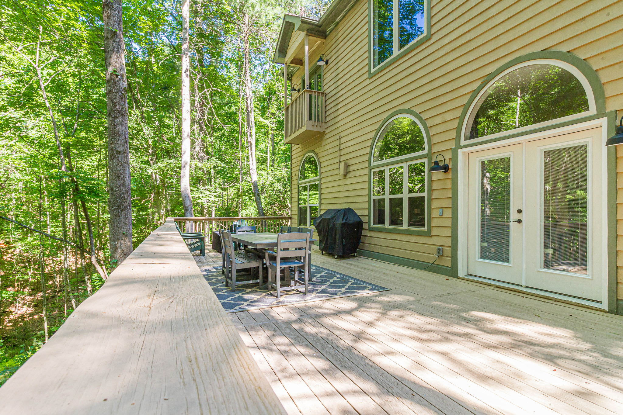 Unwind in nature with a spacious deck and green forest views.