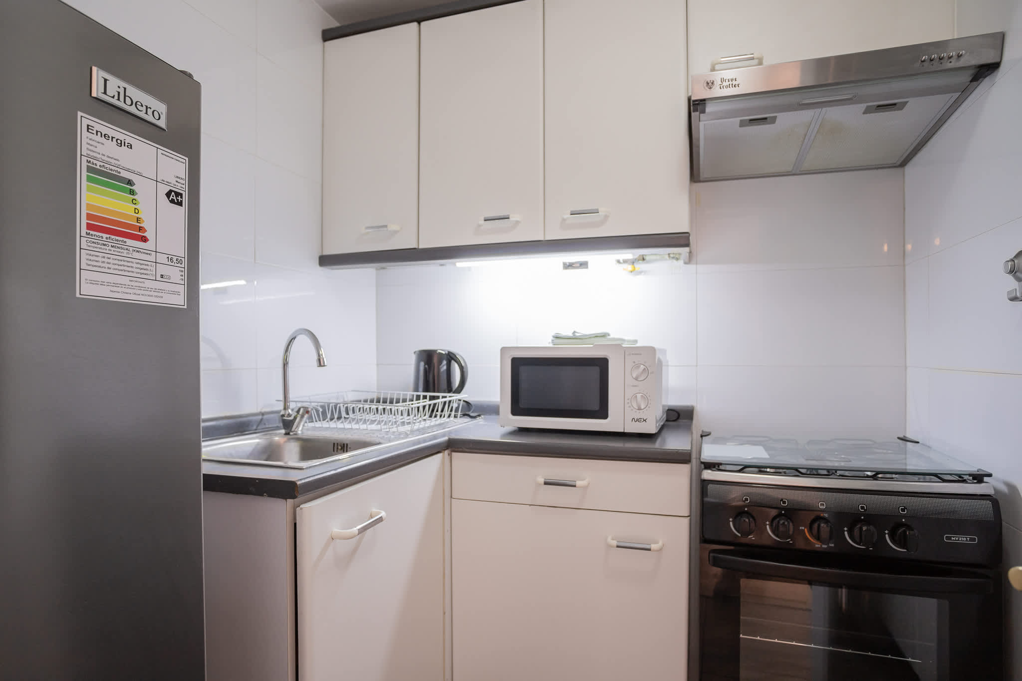 Modern and efficient kitchen equipped with essential appliances for a comfortable stay.