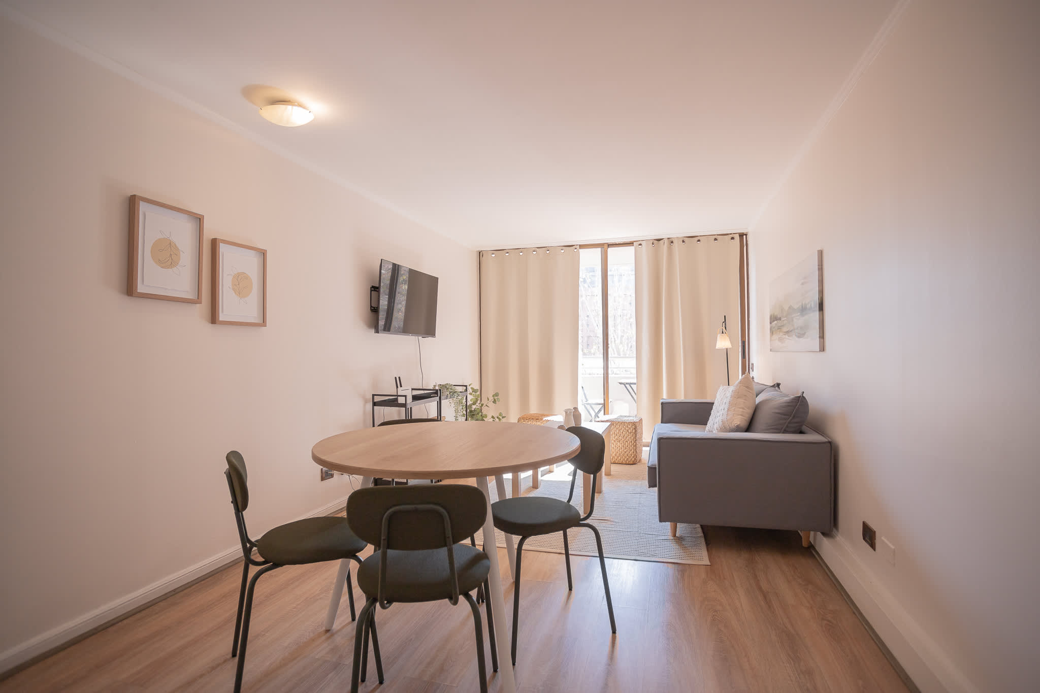 Bright and cozy living space with modern furnishings and ample natural light, perfect for relaxing or entertaining.