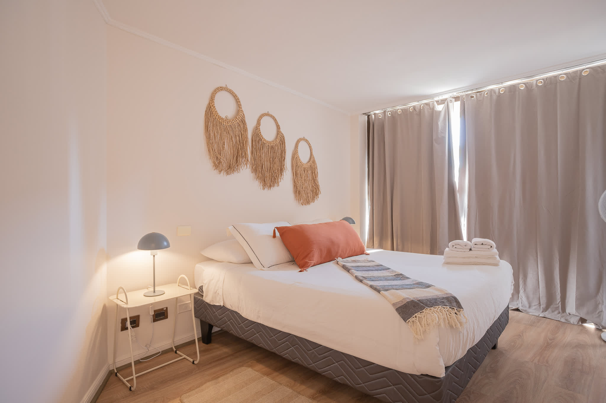Relax in this cozy bedroom with stylish decor and soft lighting, perfect for unwinding after a day of exploring.
